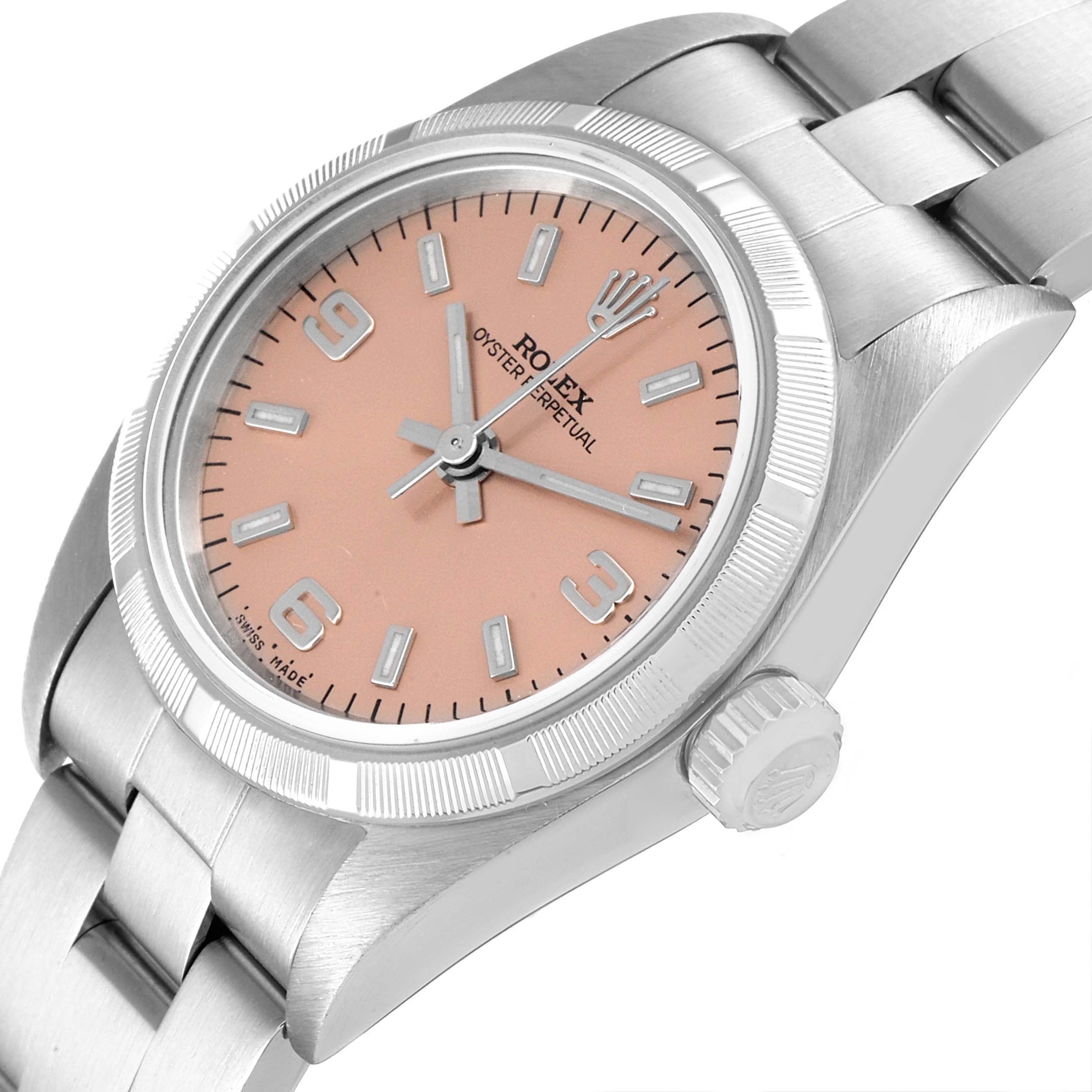 The image shows a close-up angled view of the Rolex Oyster Perpetual 76030 Women
s Stainless Steel Pink Dial 76030 Women
s Stainless Steel Pink Dial watch, highlighting its dial, crown, bezel, and part of the bracelet.