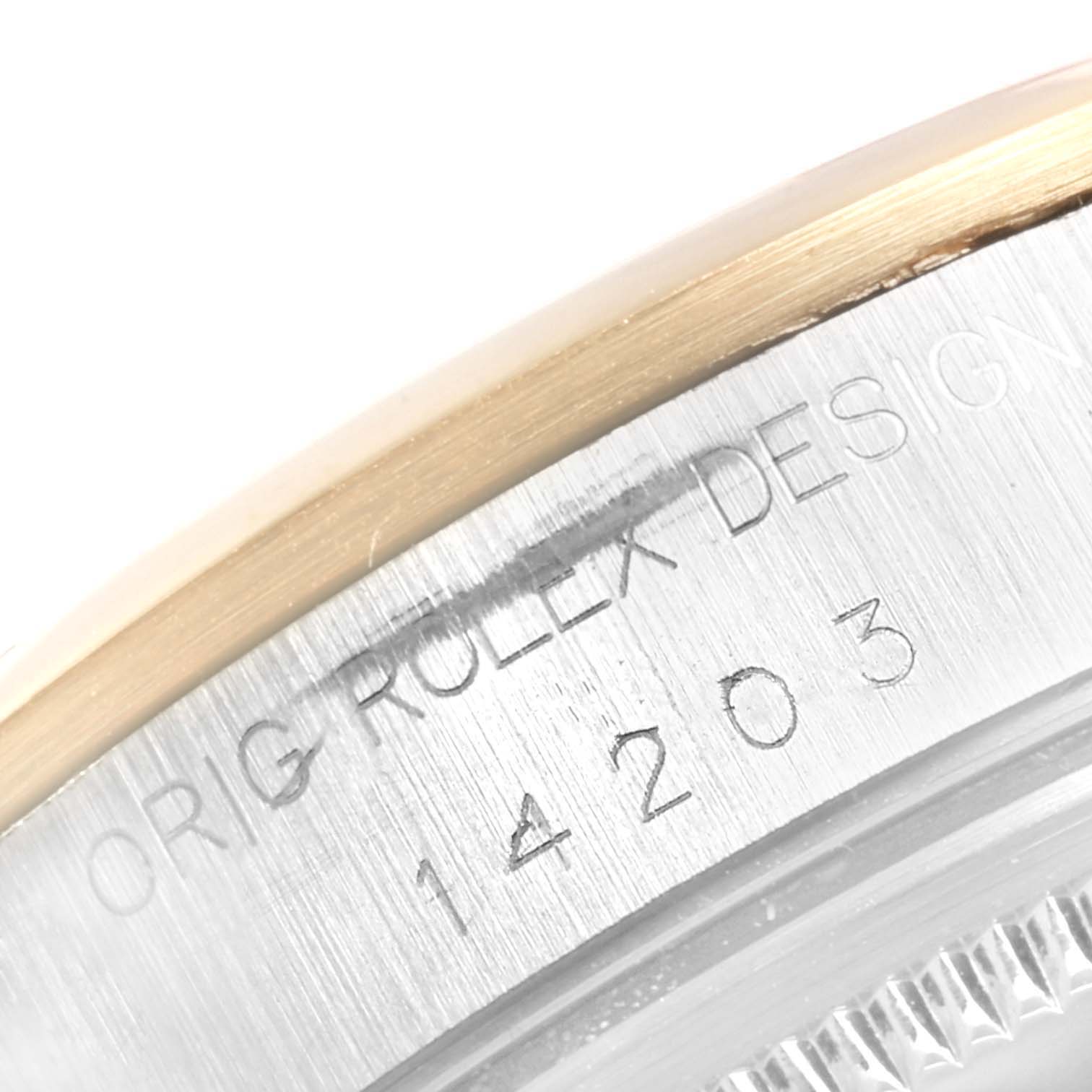 The image shows a close-up of the case side on a Rolex Oyster Perpetual 14203 Men's Steel and Gold (two tone) Blue Dial 14203 Men's Steel and Gold (two tone) Blue Dial, revealing the engraved model number "14203" and part of the bezel and caseback.