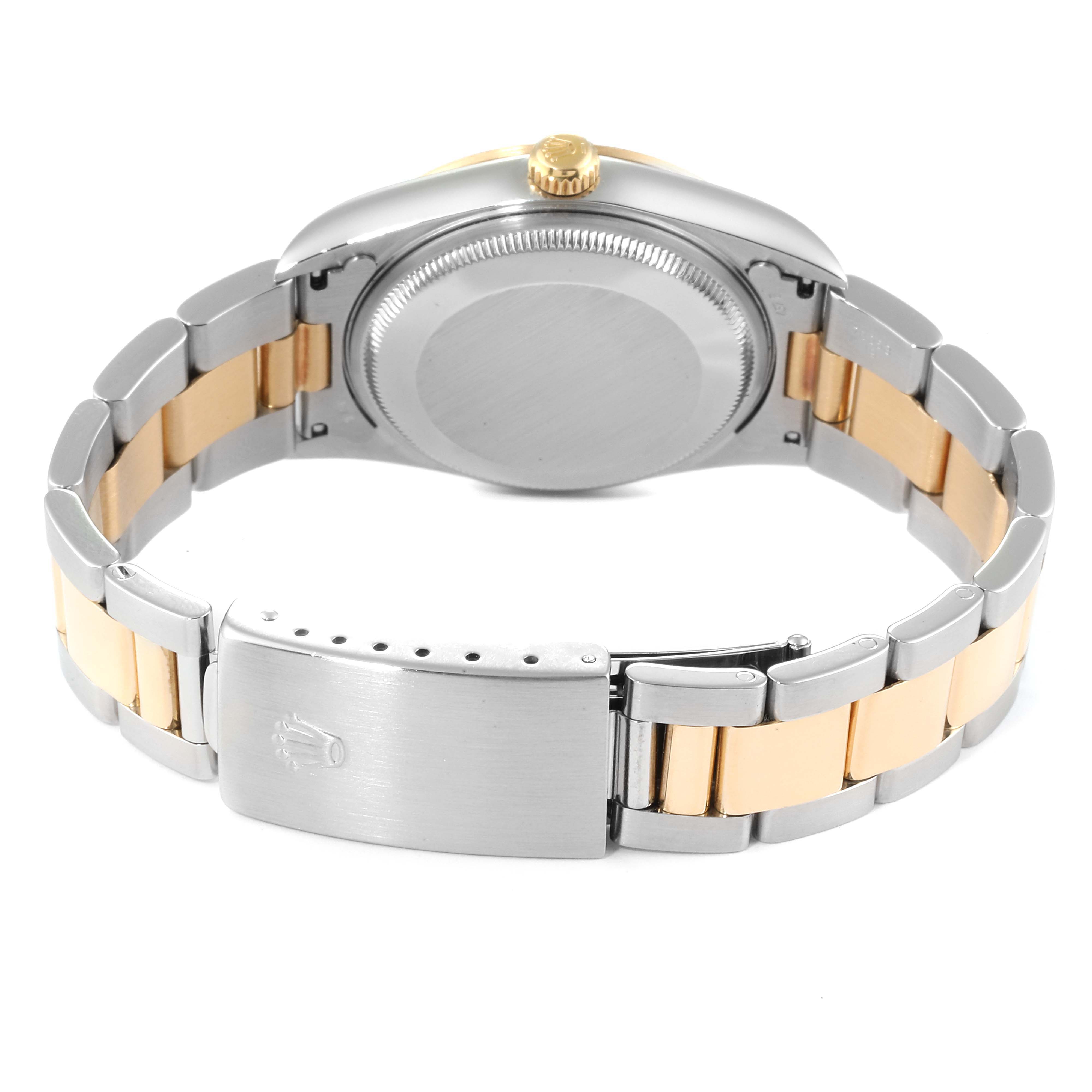 The image shows the back and the bracelet clasp of a Rolex Oyster Perpetual 14203 Men's Steel and Gold (two tone) Blue Dial 14203 Men's Steel and Gold (two tone) Blue Dial watch, emphasizing its two-tone metal design.