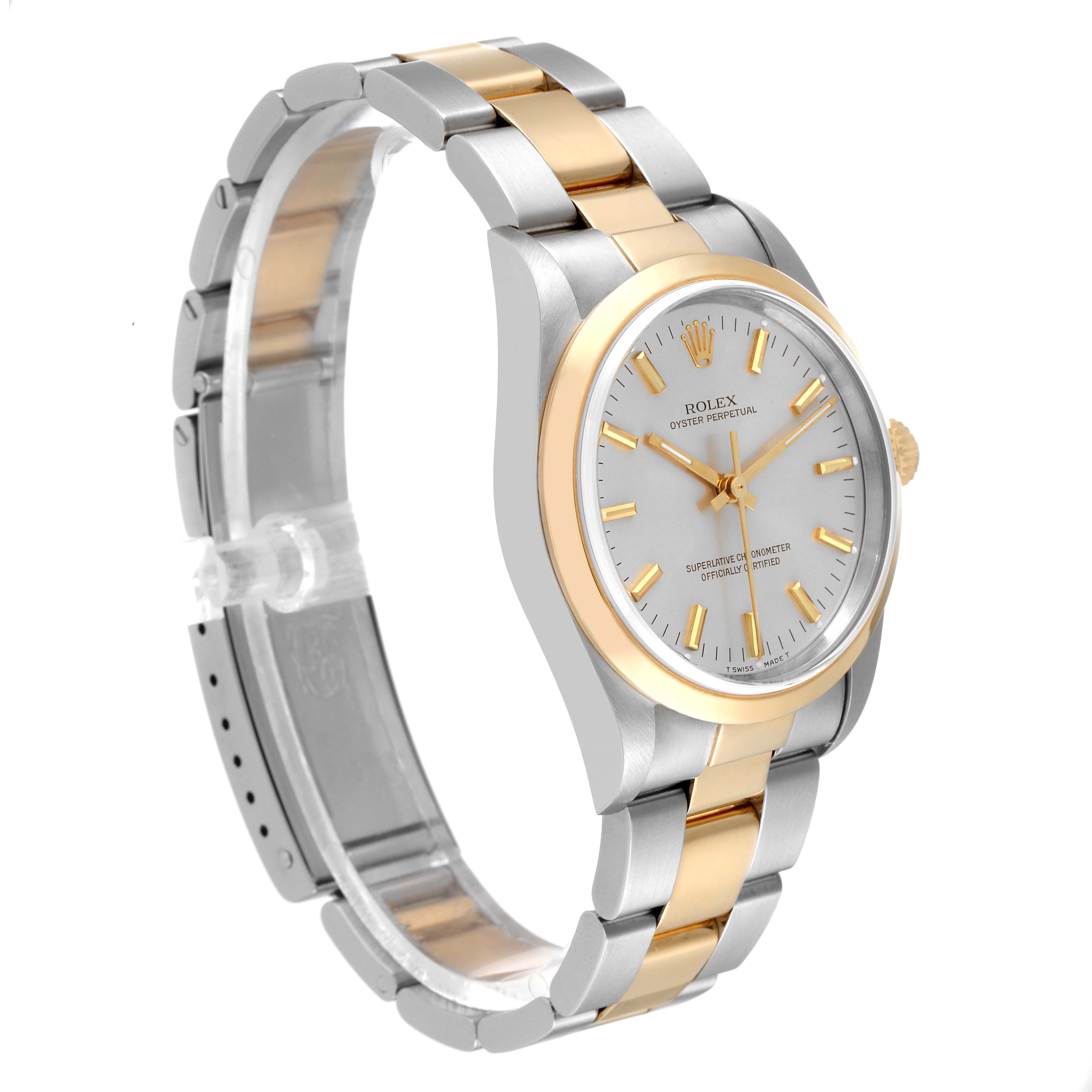 This image shows a side view of a Rolex Oyster Perpetual 14203 Men's Steel and Gold (two tone) Silver Dial 14203 Men's Steel and Gold (two tone) Silver Dial watch, highlighting its face, bezel, and two-tone bracelet.