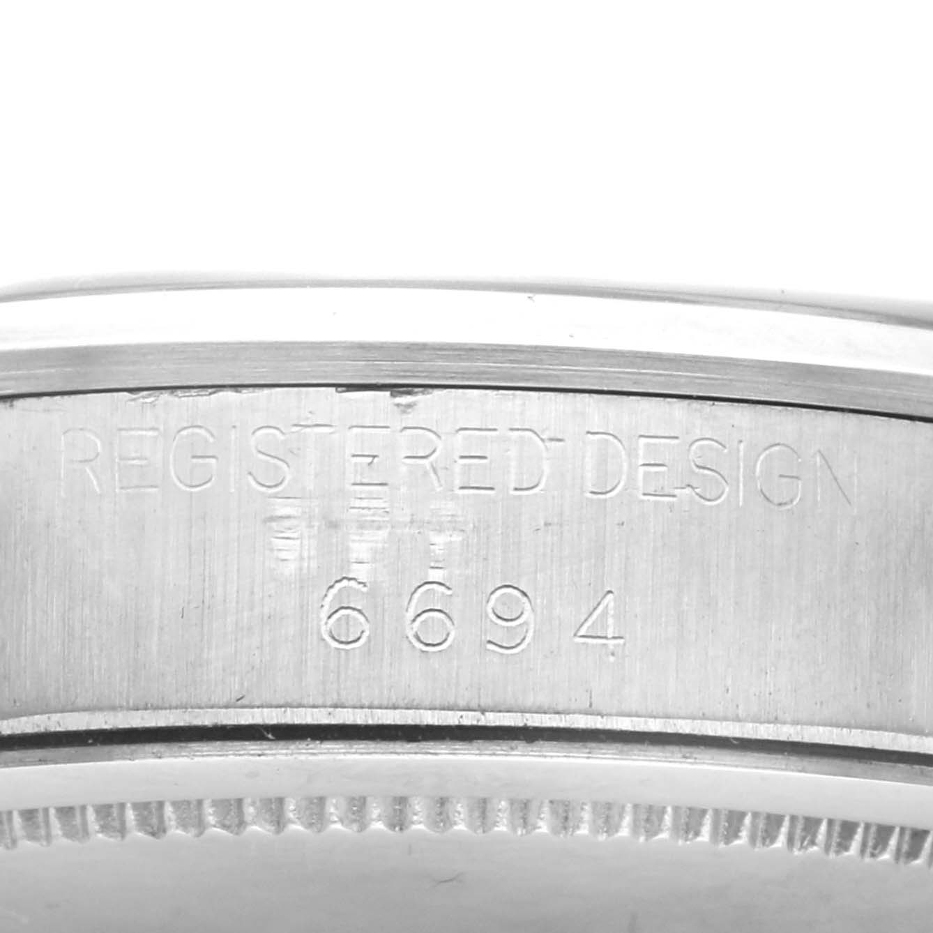 The image shows a close-up of the side case of a Rolex Vintage Collection Men
s Stainless Steel Silver Dial Men
s Stainless Steel Silver Dial watch, featuring the engraved design number.