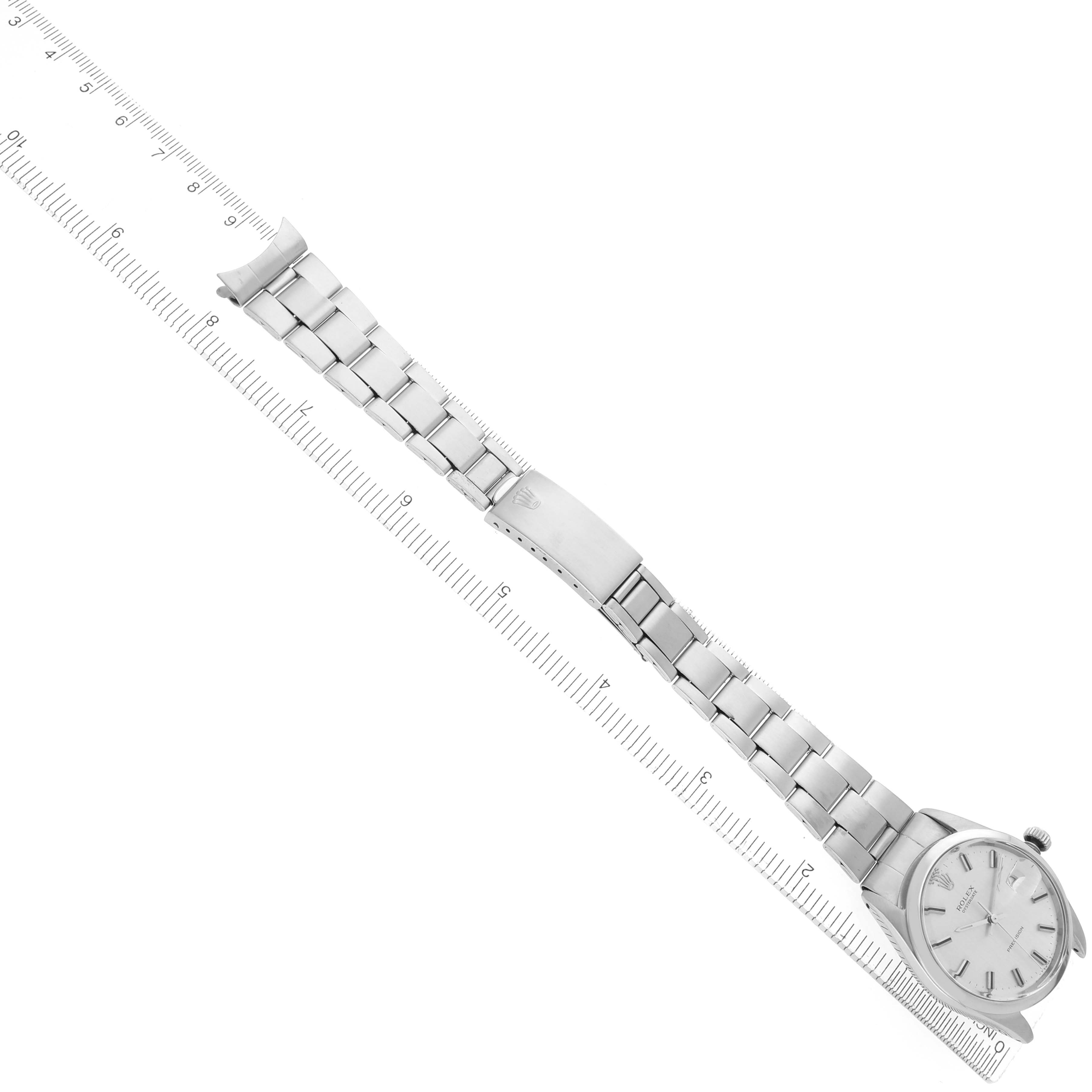 The Rolex Vintage Collection Men
s Stainless Steel Silver Dial Men
s Stainless Steel Silver Dial model is shown from an angled top view, displaying the full watch with a ruler beneath it.