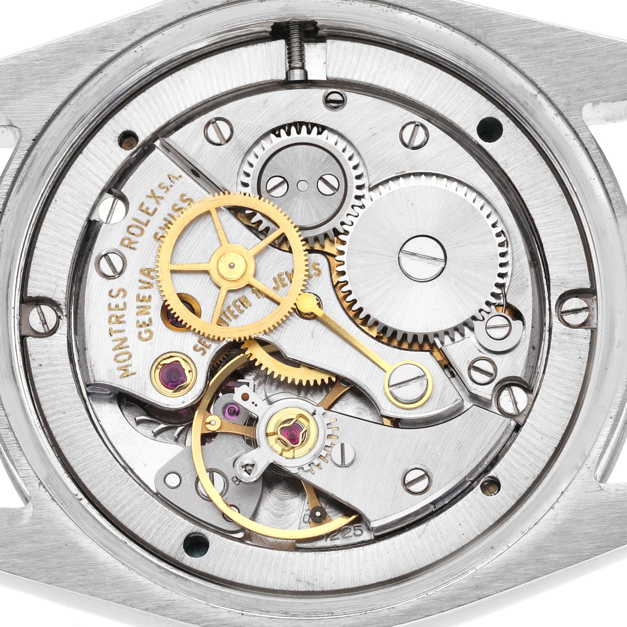 The image shows a top view of the exposed movement of a Rolex Vintage Collection Men
s Stainless Steel Silver Dial Men
s Stainless Steel Silver Dial watch, featuring gears and jeweled components.
