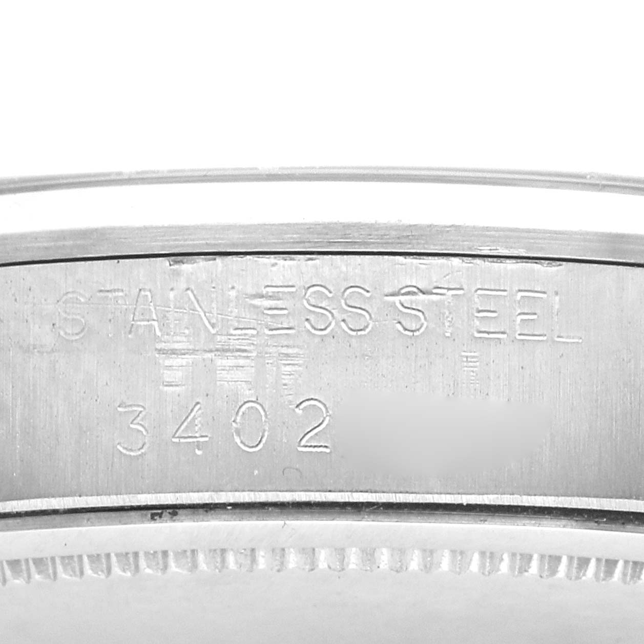 The image shows the side of a Rolex Vintage Collection Men
s Stainless Steel Silver Dial Men
s Stainless Steel Silver Dial watch case, focusing on the engraved "STAINLESS STEEL" and model number "3402".