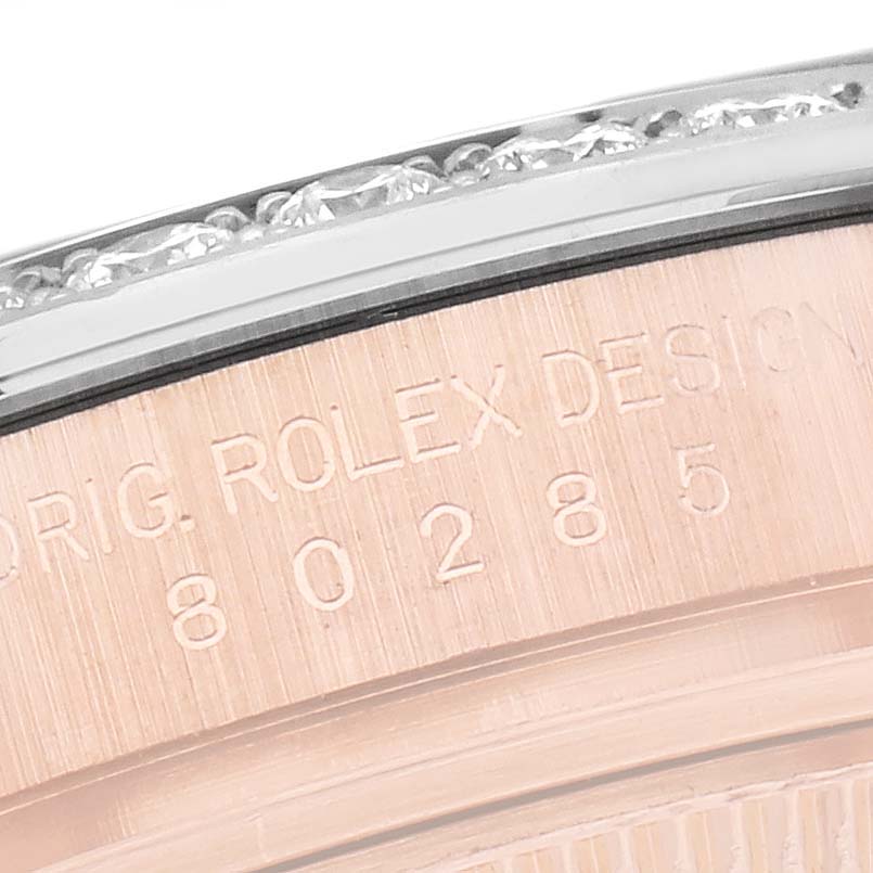 The image shows a close-up of the engraved edge and bezel of a Rolex Pearlmaster 80285 Women
s Rose Gold Pink Dial 80285 Women
s Rose Gold Pink Dial watch.
