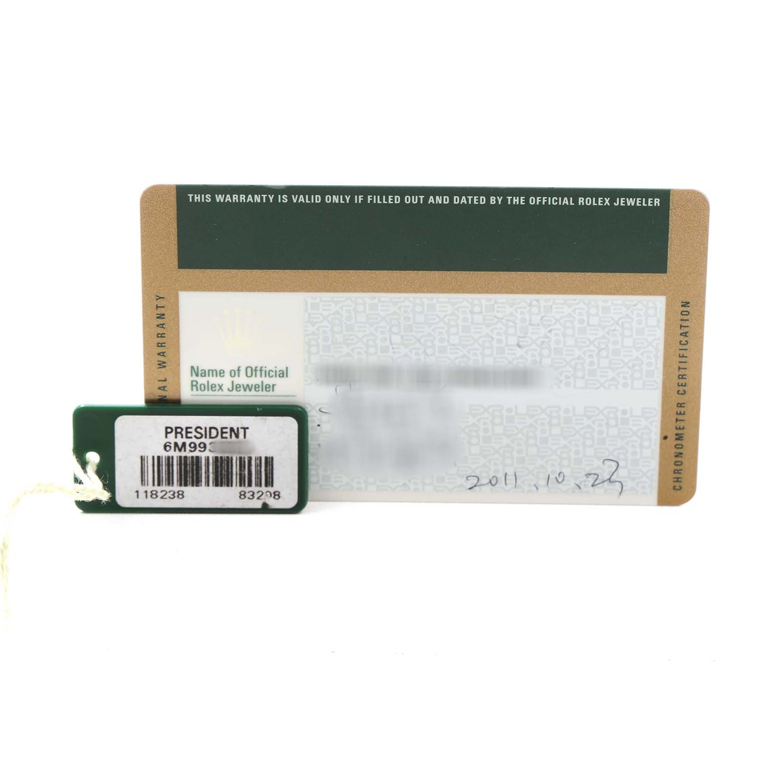 The image shows a warranty card and tag for the Rolex President 118238 Men's Yellow Gold Champagne Dial model, displaying details and branding.