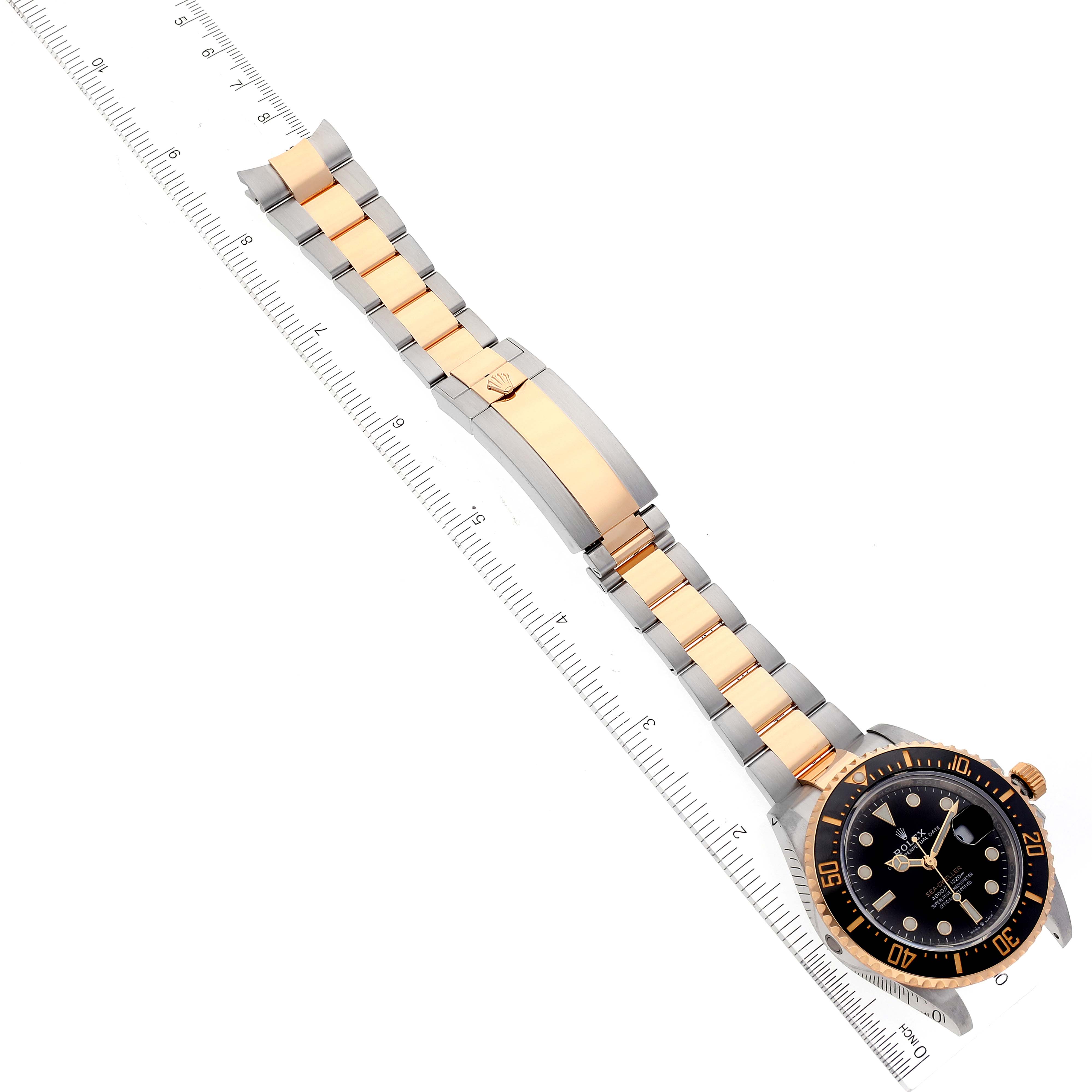 The Rolex Sea-Dweller 126603 Men
s Steel and Gold (two tone) Black Dial 126603 Men
s Steel and Gold (two tone) Black Dial watch is shown from an overhead angle, displaying the dial, bezel, and full bracelet, measured with a ruler.