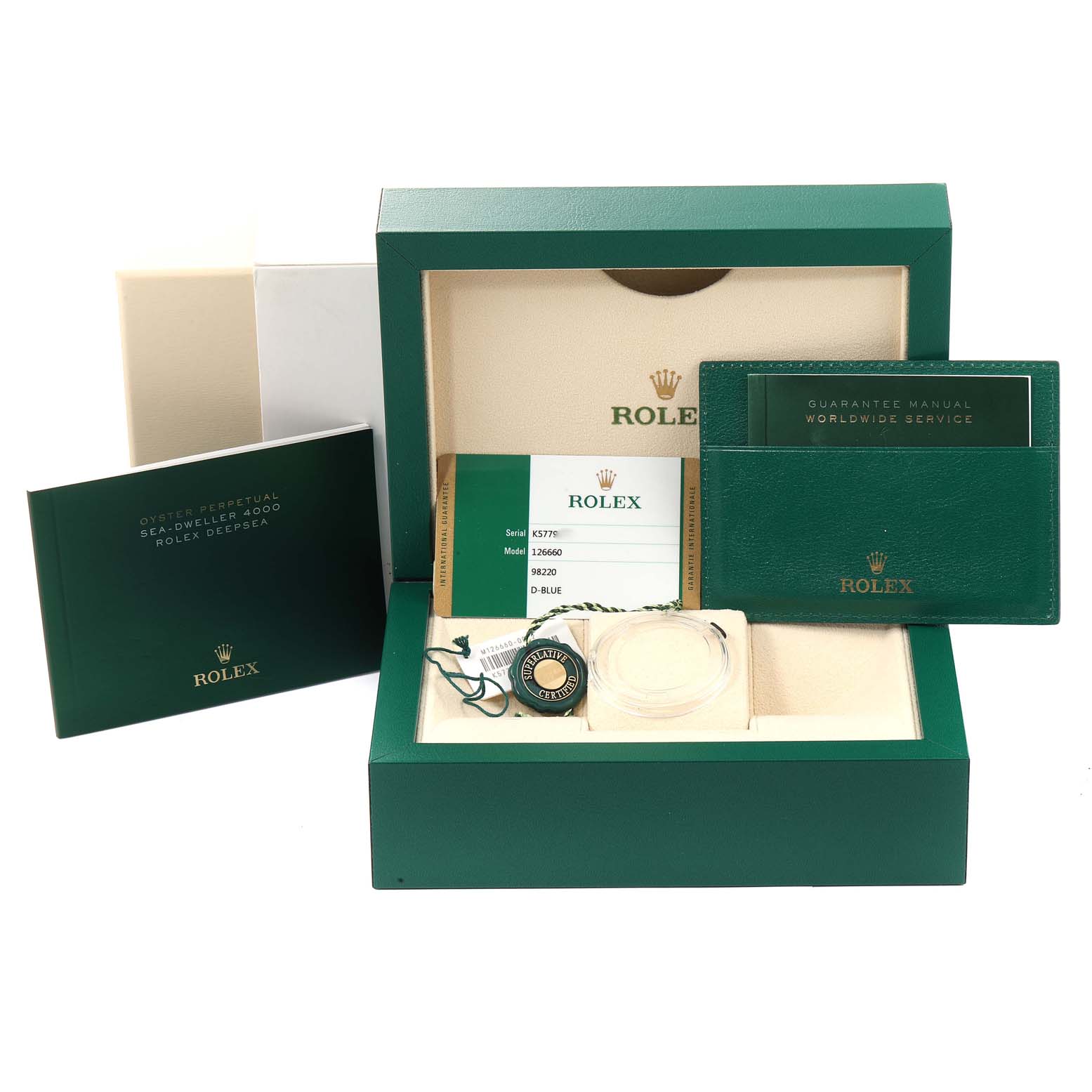 The image shows the open box of a Rolex Sea-Dweller 126660 Men
s Stainless Steel Blue Dial 126660 Men
s Stainless Steel Blue Dial watch with manuals, tags, and warranty card.