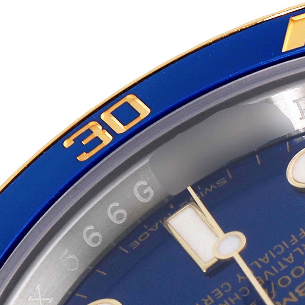 This close-up image of a Rolex Submariner 116613 Men
s Steel and Gold (two tone) Blue Dial 116613 Men
s Steel and Gold (two tone) Blue Dial watch shows part of the bezel with the "30" marker and part of the blue dial.