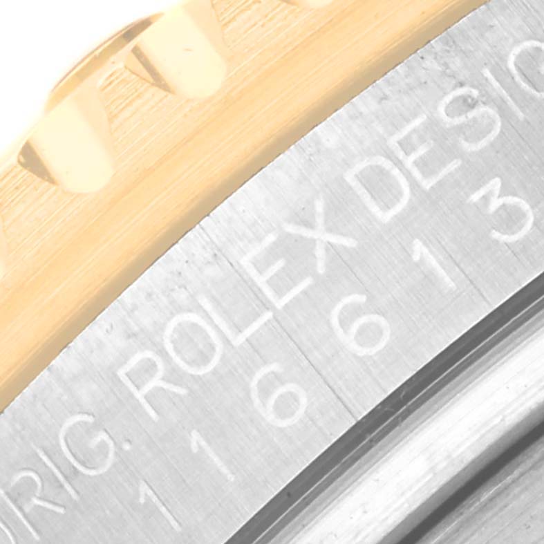 The image shows a macro shot of the case and part of the bezel of a Rolex Submariner 116613 Men's Steel and Gold (two tone) Blue Dial 116613 Men's Steel and Gold (two tone) Blue Dial watch, highlighting the model number engraved.