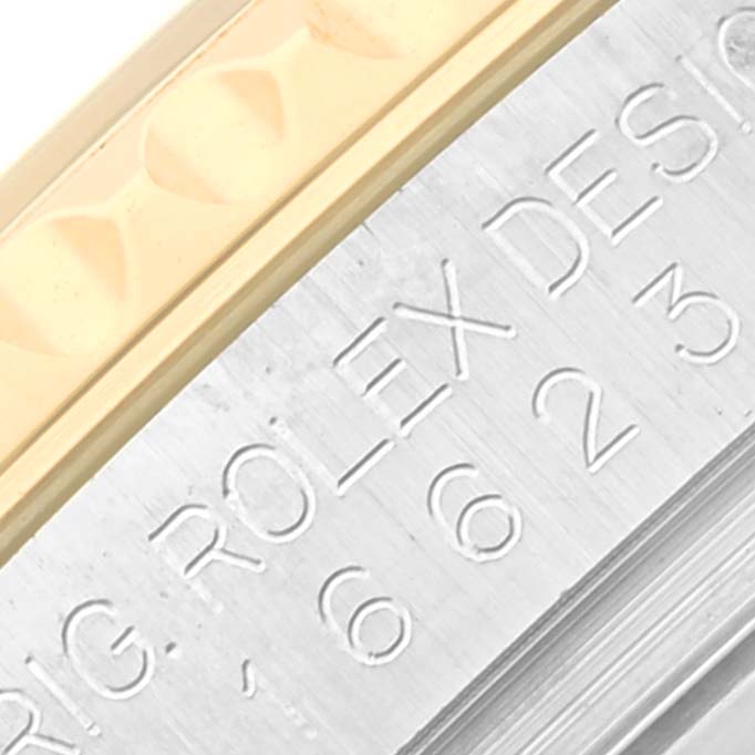 The image shows a close-up of the Rolex Yacht-Master 16623 Men's Steel and Gold (two tone) White Dial's engraved watch case side, highlighting the bezel's edge.