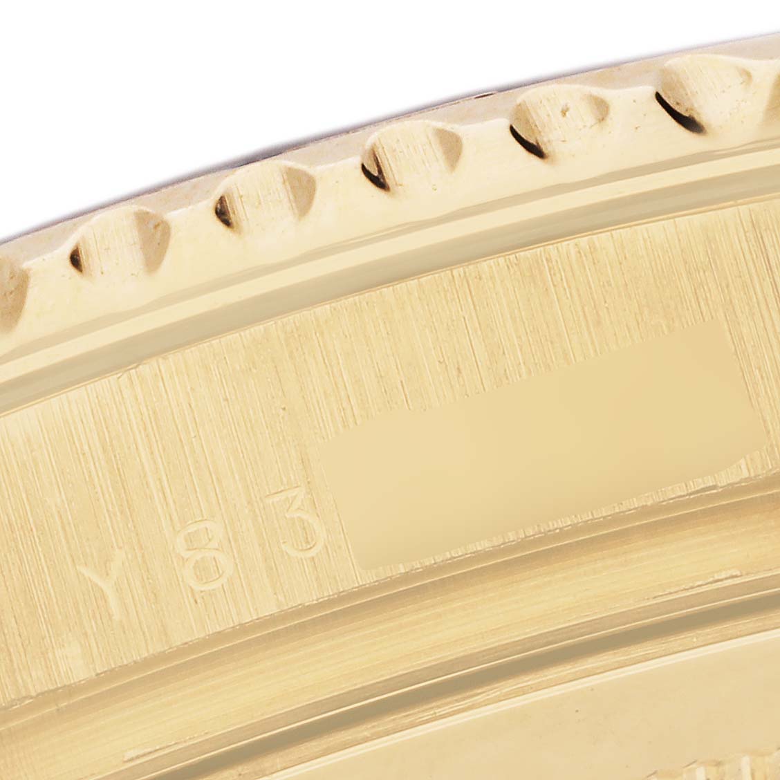 This image shows a close-up of the bezel and part of the engraved serial number on a Rolex Yacht-Master 16628 Men's Yellow Gold Mother of Pearl Dial 16628 Men's Yellow Gold Mother of Pearl Dial watch.