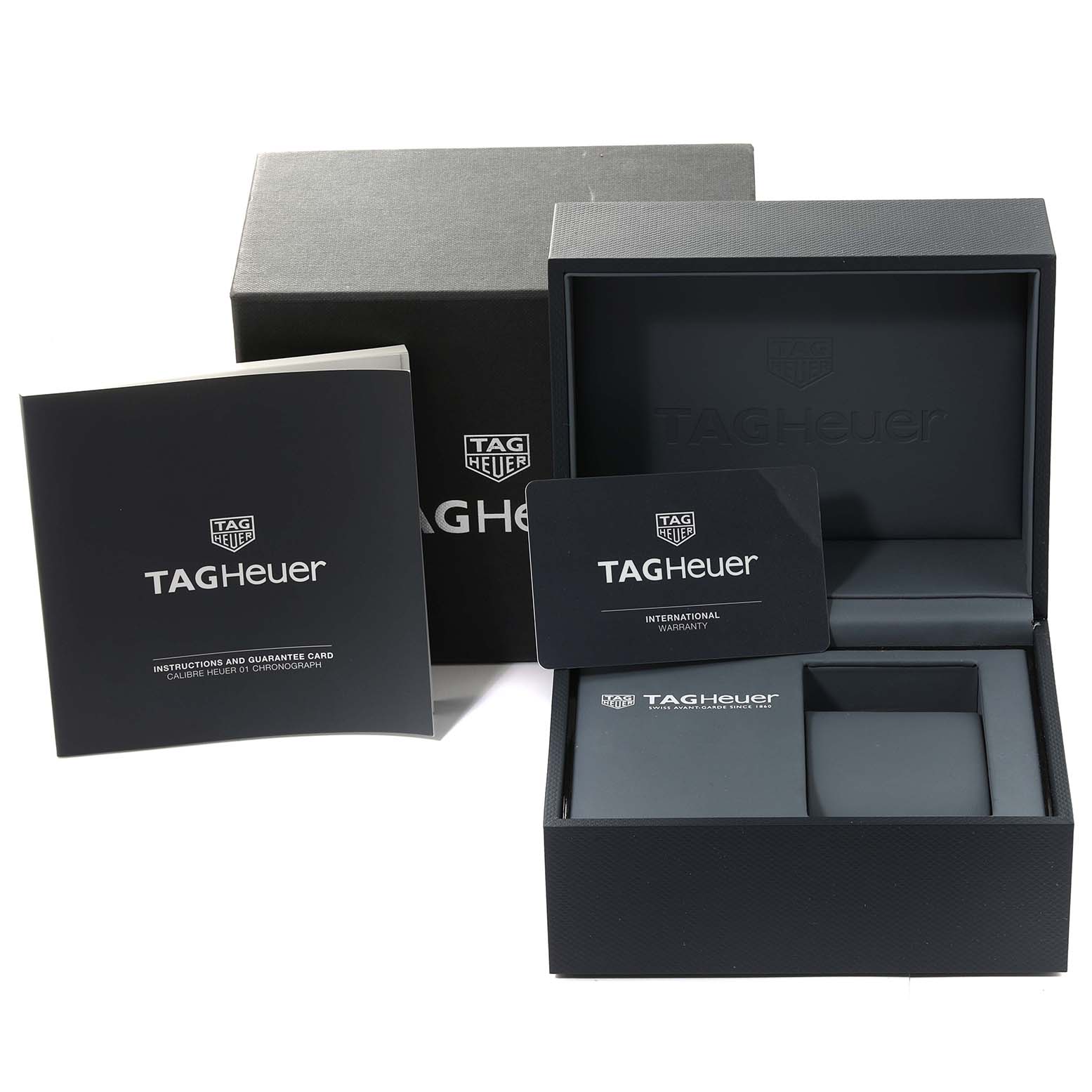 The image shows the box, international warranty card, and manuals for the Carrera model by Tag Heuer.