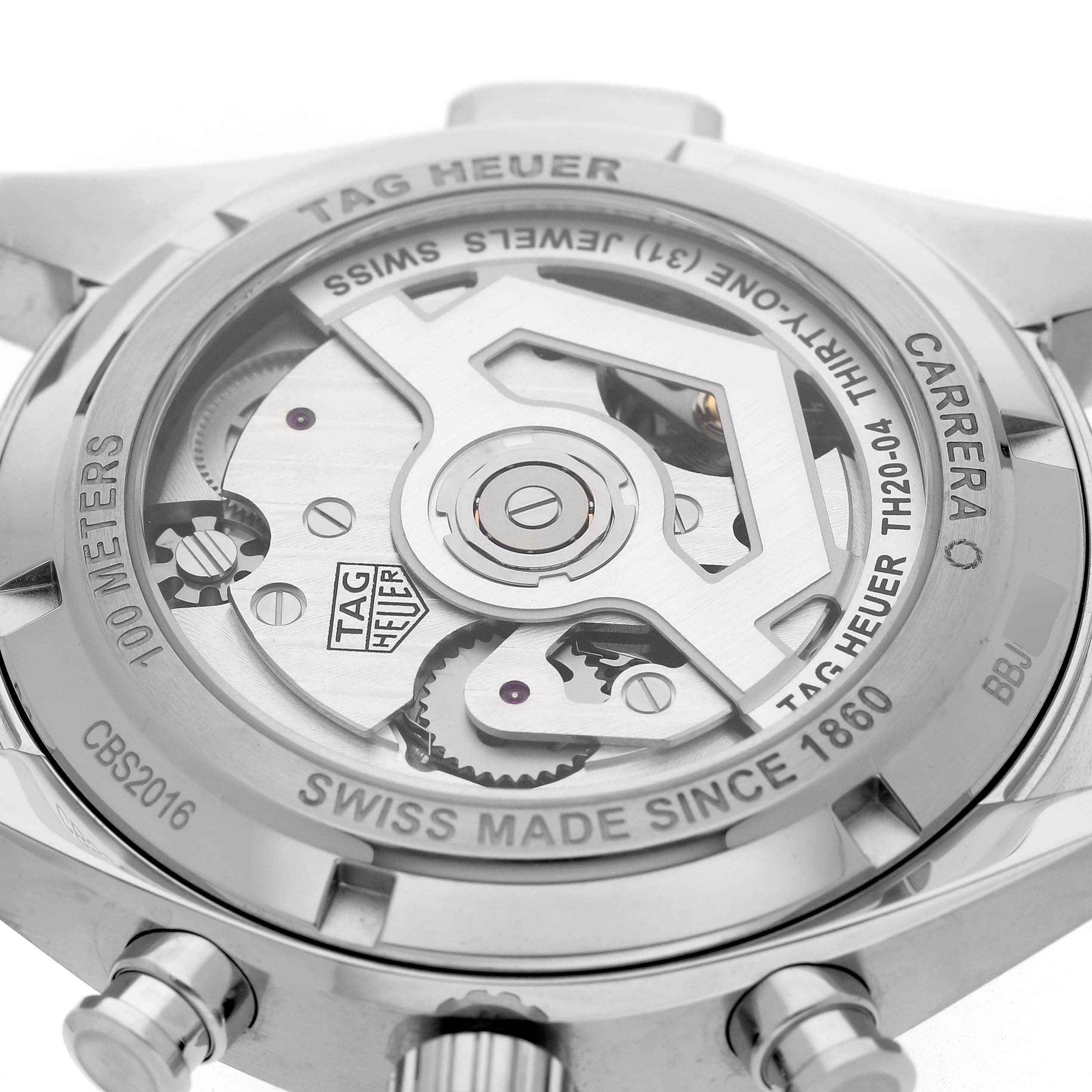 The image shows the back of a Tag Heuer Carrera CBS2016.EB0430 Men's Stainless Steel Beige Dial watch, displaying its mechanical movement and transparent case back.