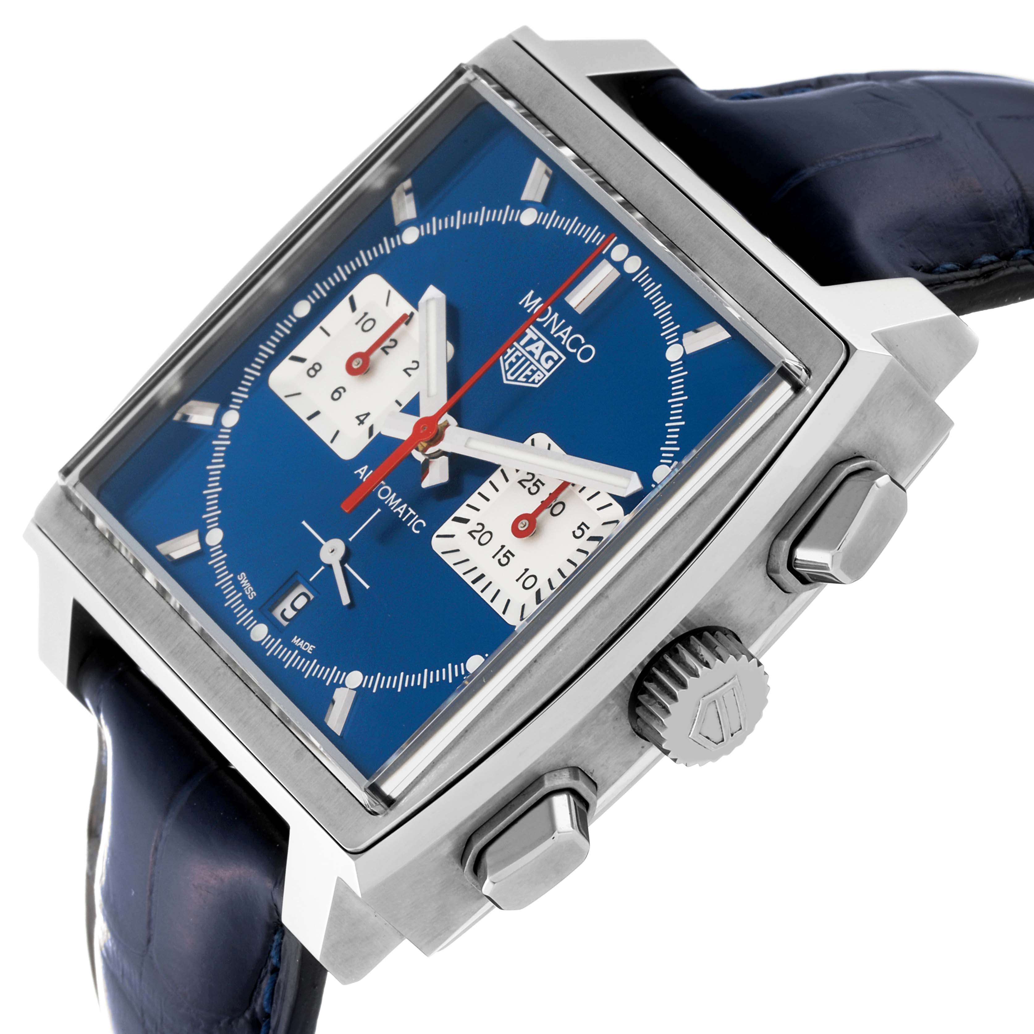 The image shows a Tag Heuer Monaco watch with a blue dial, side buttons, and crown at an angled view.