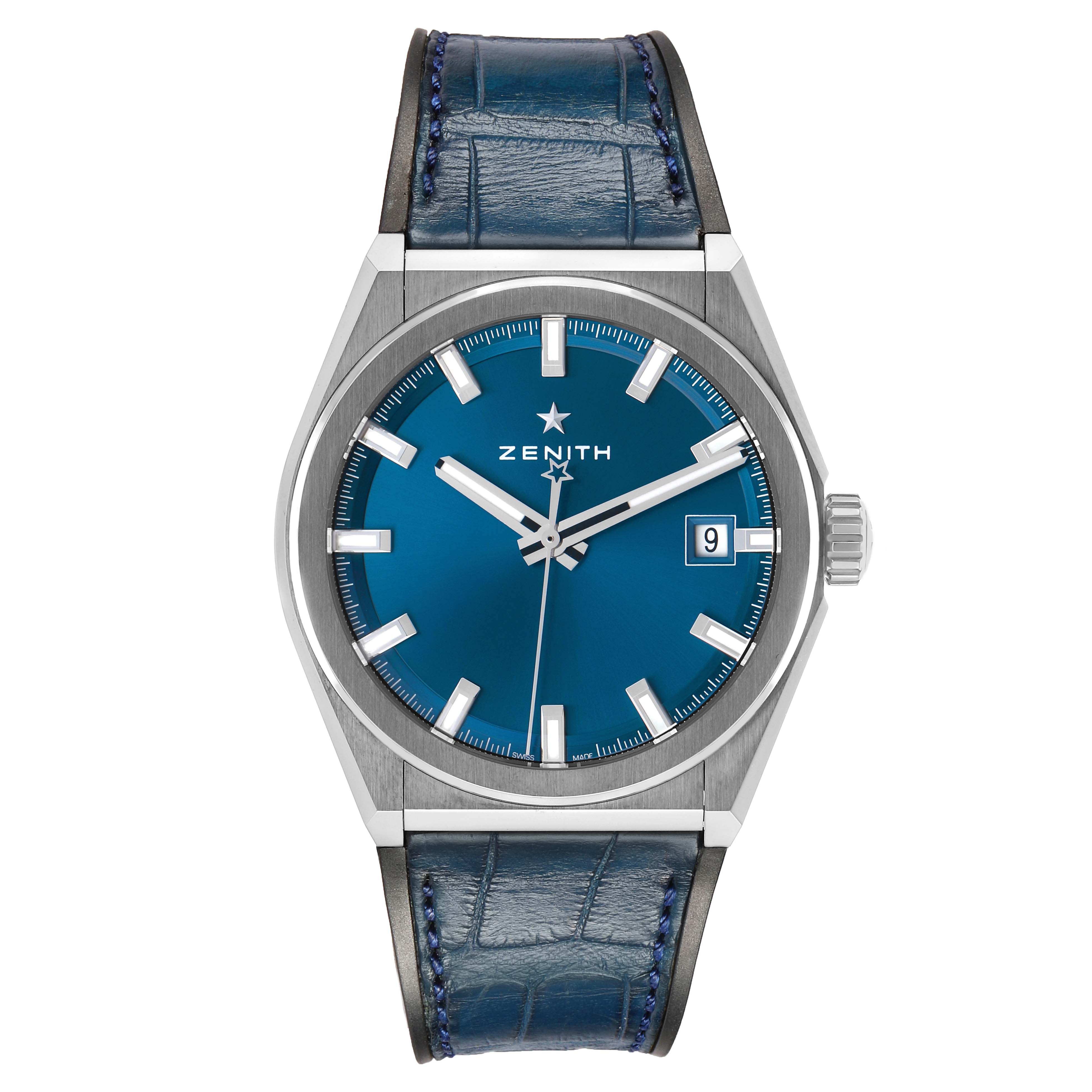 The Zenith Defy 95.9000.670/51.M9000 Men's Titanium Blue Dial watch is shown from a front angle, displaying its blue dial, silver hands, date window, and leather strap.