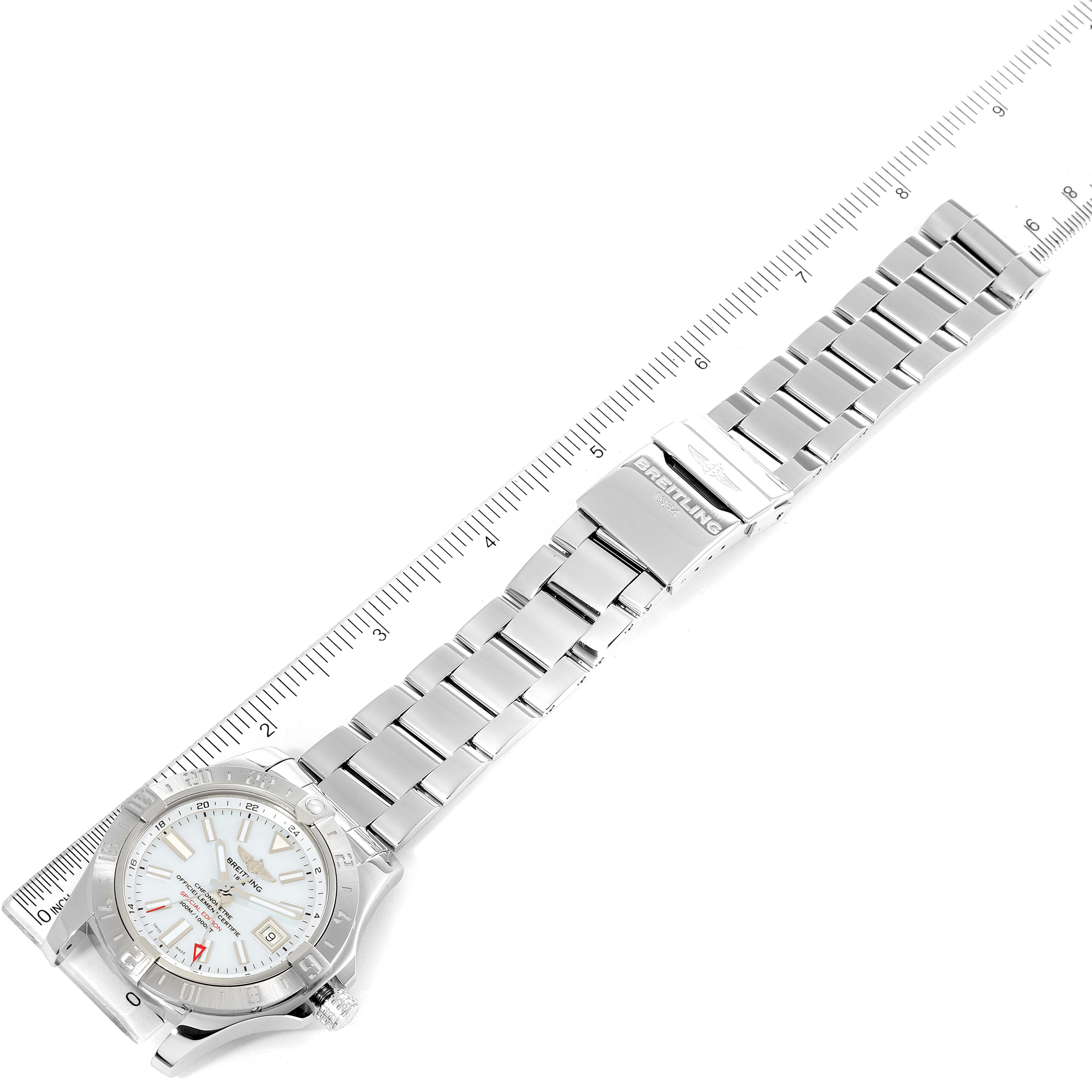 The image shows a Breitling Avenger A3239011-C872-170A Men
s Stainless Steel Mother of Pearl Dial A3239011-C872-170A Men
s Stainless Steel Mother of Pearl Dial watch, including the watch face, bracelet, and clasp from a top-down angle next to a ruler.