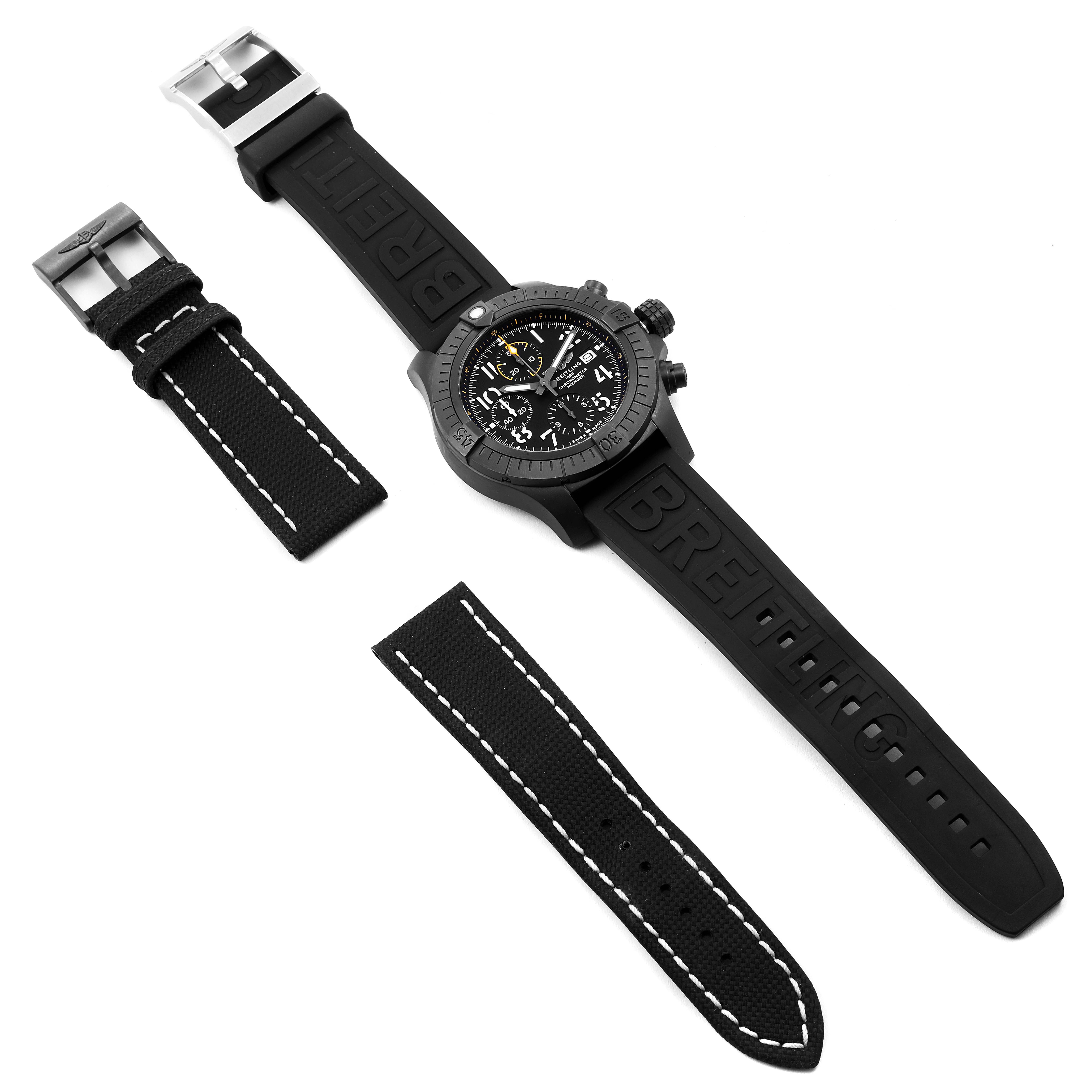 The image shows a Breitling Avenger V13317 Men's Titanium Black Dial V13317 Men's Titanium Black Dial watch with a black rubber strap and two additional fabric straps alongside.
