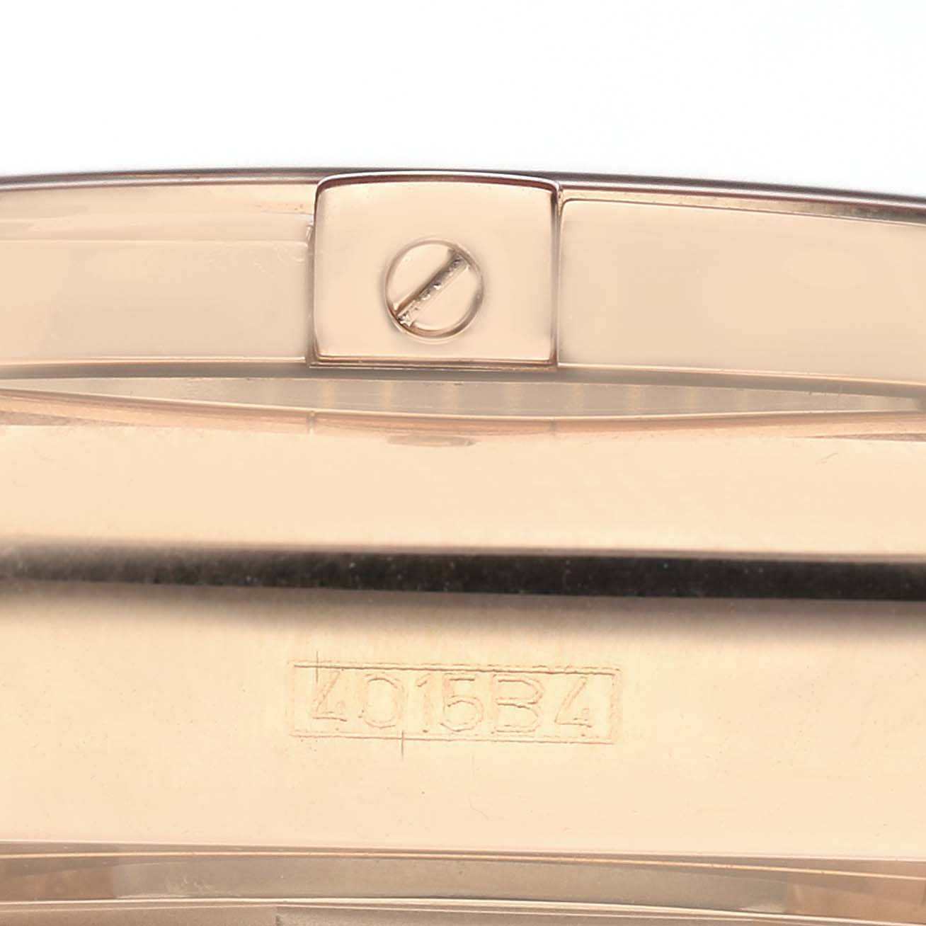 The image shows the clasp of a Breitling Chronomat HB01115W/BE53 Men
s Rose Gold Black Dial HB01115W/BE53 Men
s Rose Gold Black Dial watch, featuring a visible screw and serial number.