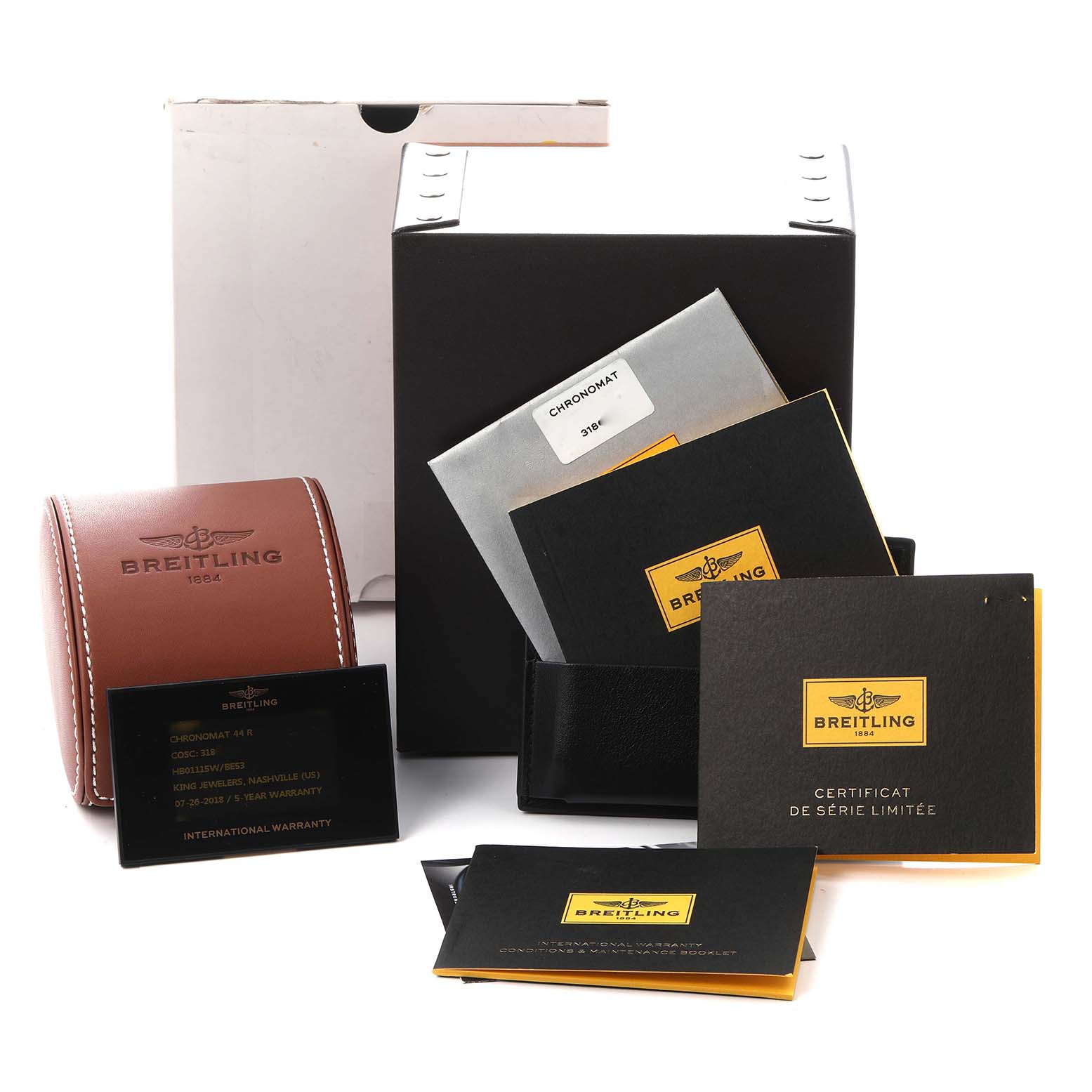 The image shows accessories for a Breitling Chronomat HB01115W/BE53 Men
s Rose Gold Black Dial HB01115W/BE53 Men
s Rose Gold Black Dial, including manuals, warranty cards, and a leather case.