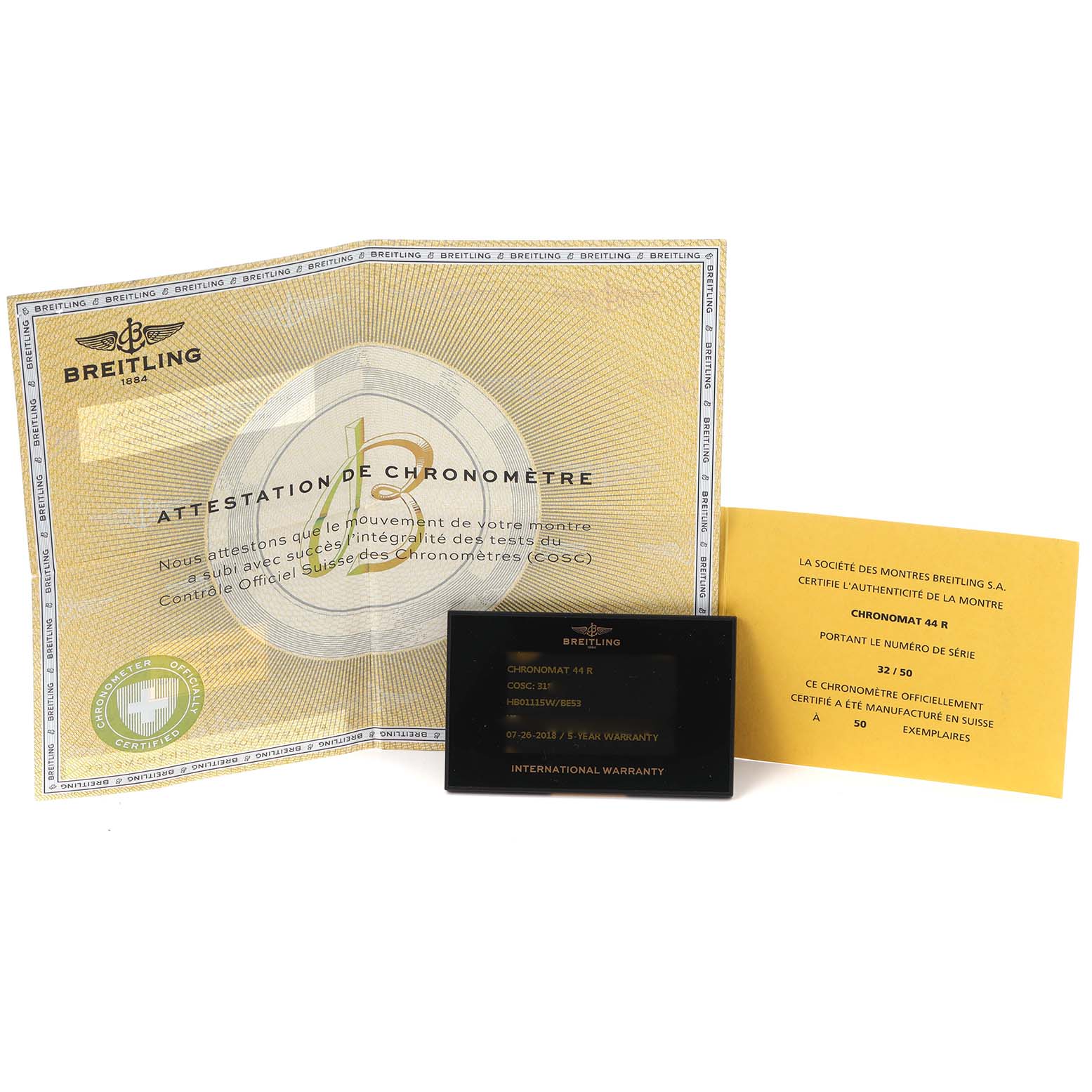 The image shows Breitling Chronomat HB01115W/BE53 Men
s Rose Gold Black Dial HB01115W/BE53 Men
s Rose Gold Black Dial model warranty cards and certificates from a top-down angle.