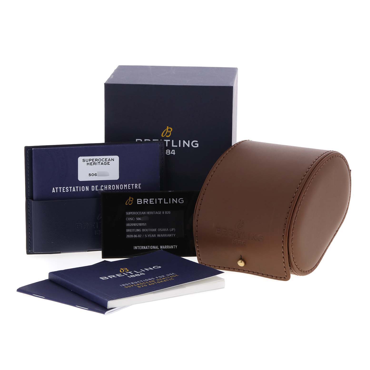 The image shows the packaging, international warranty card, paperwork, and a leather watch case for the Breitling Superocean UB201012/BG53/154A Men
s Stainless Steel Black Dial UB201012/BG53/154A Men
s Stainless Steel Black Dial model.