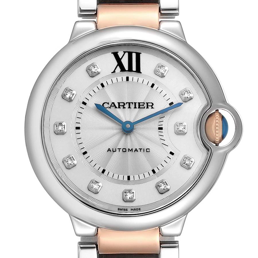 The Cartier Ballon Bleu watch is shown from the front, highlighting its round face, blue hands, Roman numeral XII, and diamond markers.