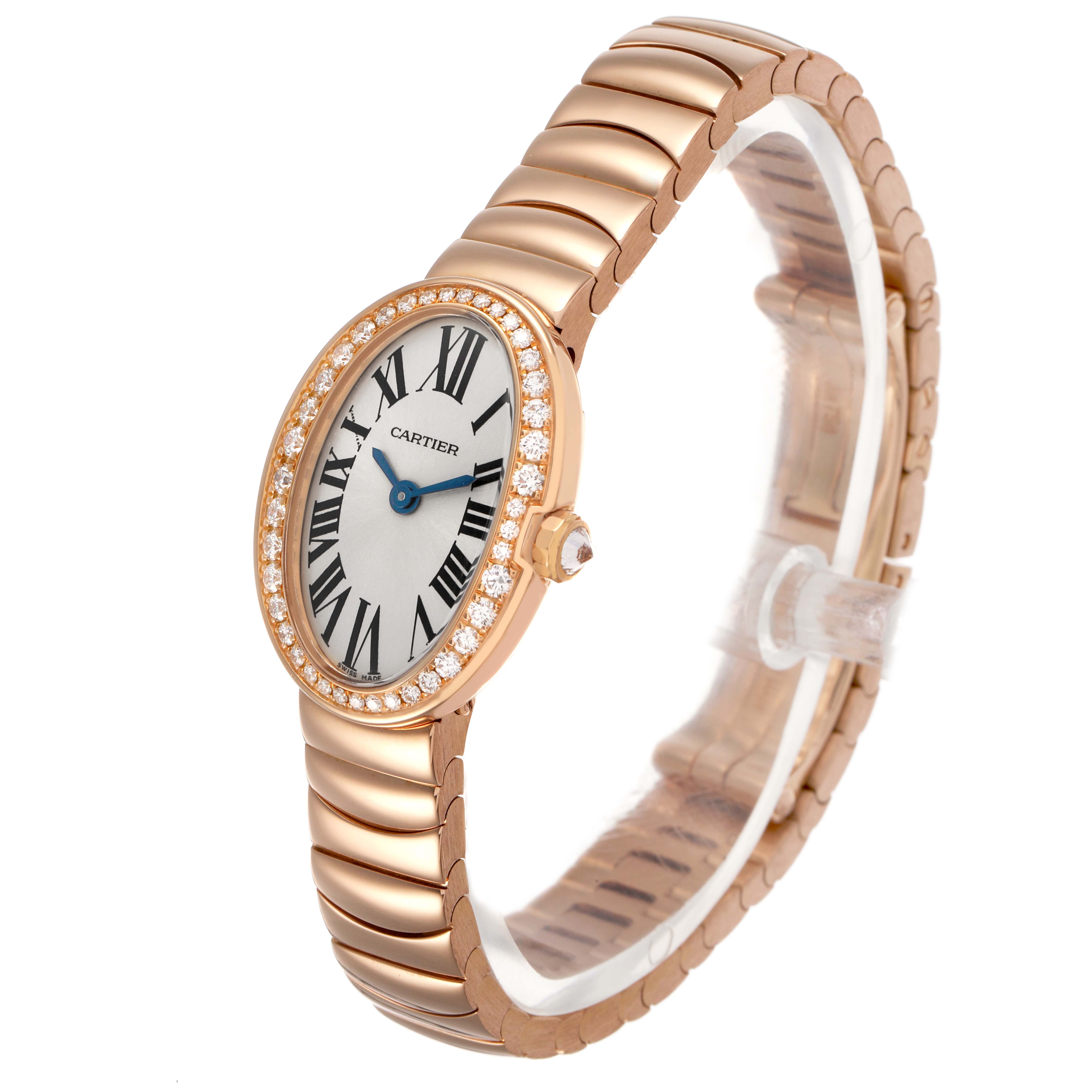 The Cartier Baignoire WB520026 Women's Rose Gold Silver Dial watch is shown at an angled side view, highlighting the oval face, diamond bezel, and metal bracelet.