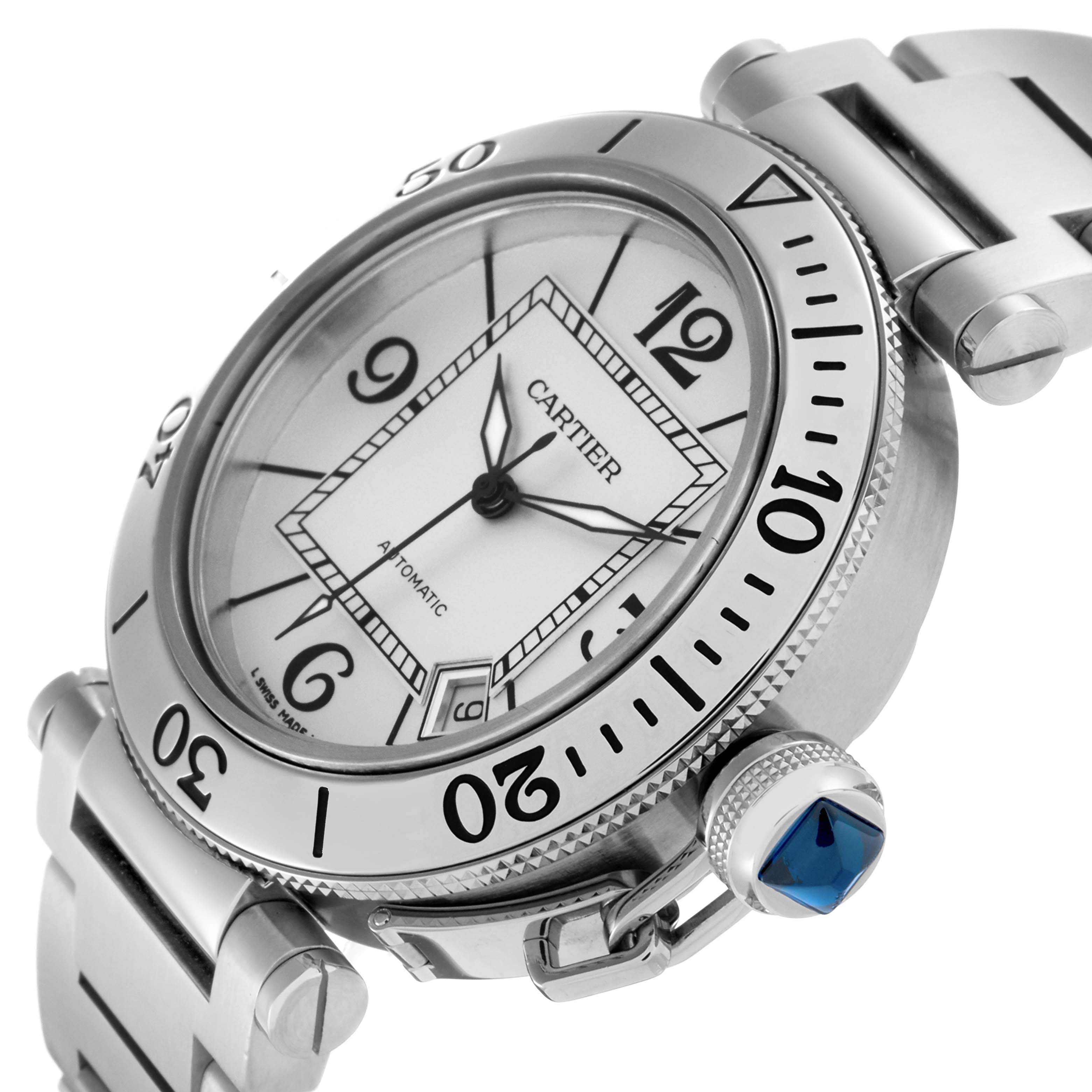 The Cartier Pasha W31080M7 Men
s Stainless Steel Silver Dial W31080M7 Men
s Stainless Steel Silver Dial watch is shown from an angled close-up, highlighting the dial, bezel, and blue cabochon crown.