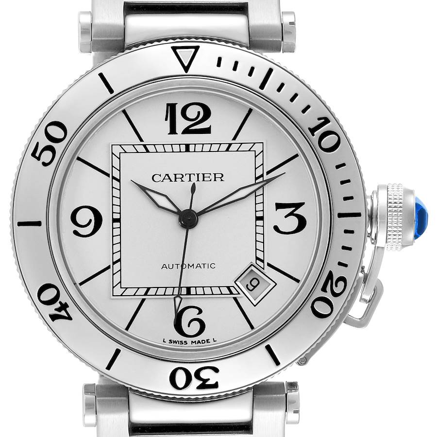 The Cartier Pasha watch is shown from a front angle, displaying the bezel, dial, crown with a blue cabochon, and parts of the bracelet.