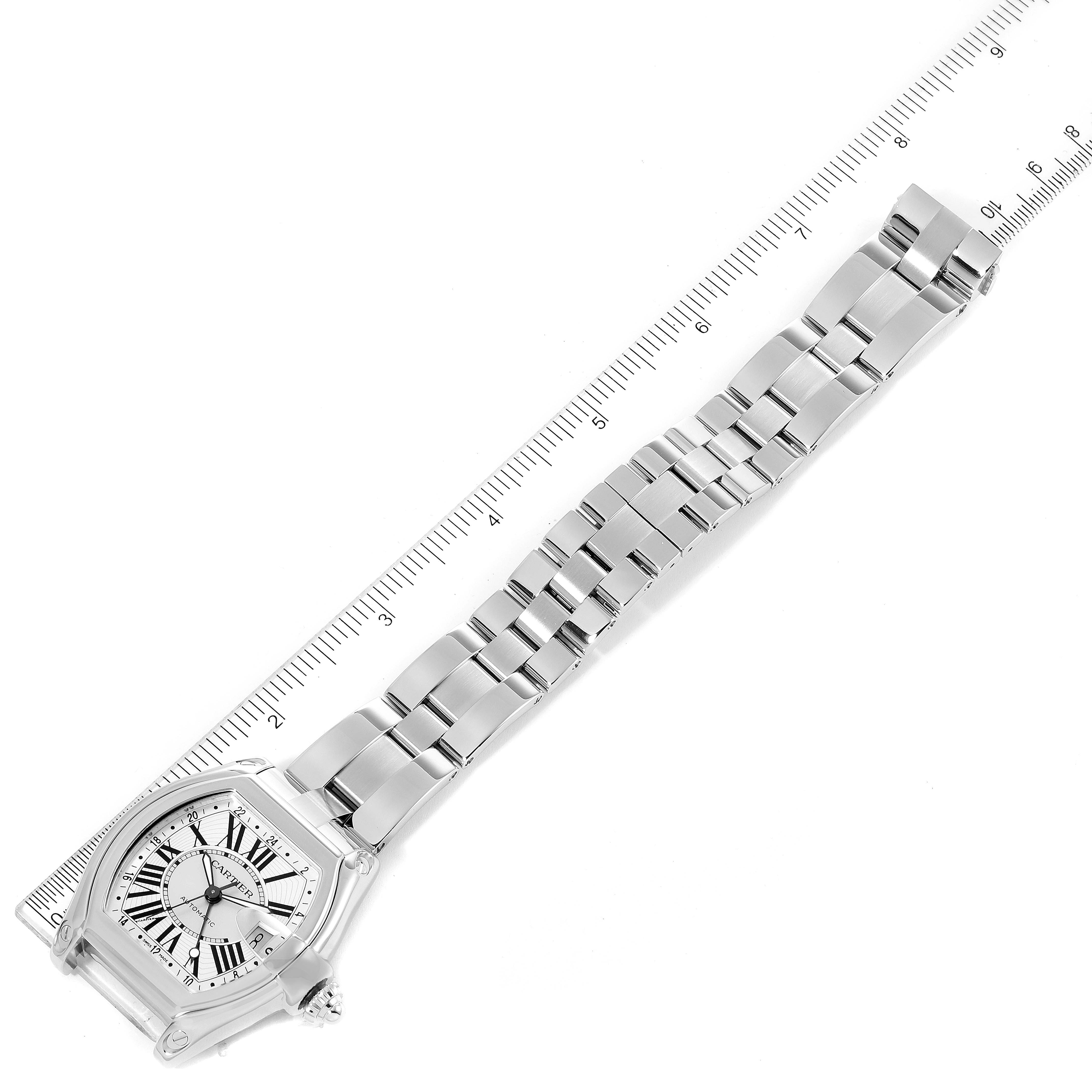 The image shows the Cartier Roadster W62032X6 Men
s Stainless Steel Silver Dial W62032X6 Men
s Stainless Steel Silver Dial watch laid flat, displaying the bracelet and face with a ruler for measurement.