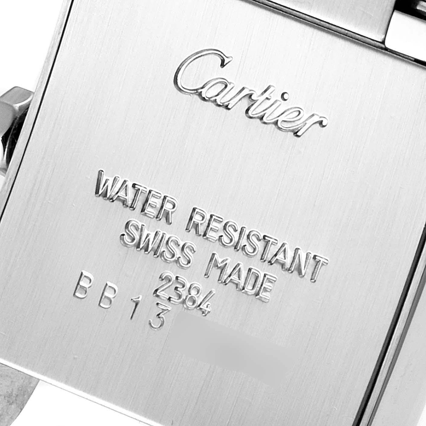 This image shows the recessed case back of a Cartier Tank Francaise W51008Q3 Women
s Stainless Steel Silver Dial W51008Q3 Women
s Stainless Steel Silver Dial watch, highlighting its water resistance and Swiss-made engravings.