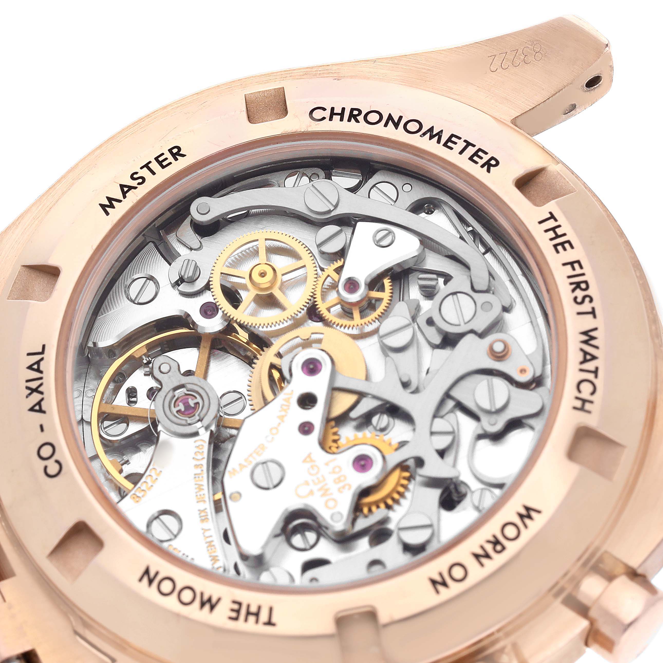 The image shows the Omega Speedmaster 310.60.42.50.01.001 Men's Rose Gold Black Dial's inner mechanics from the back, highlighting gears and components through the transparent case back.