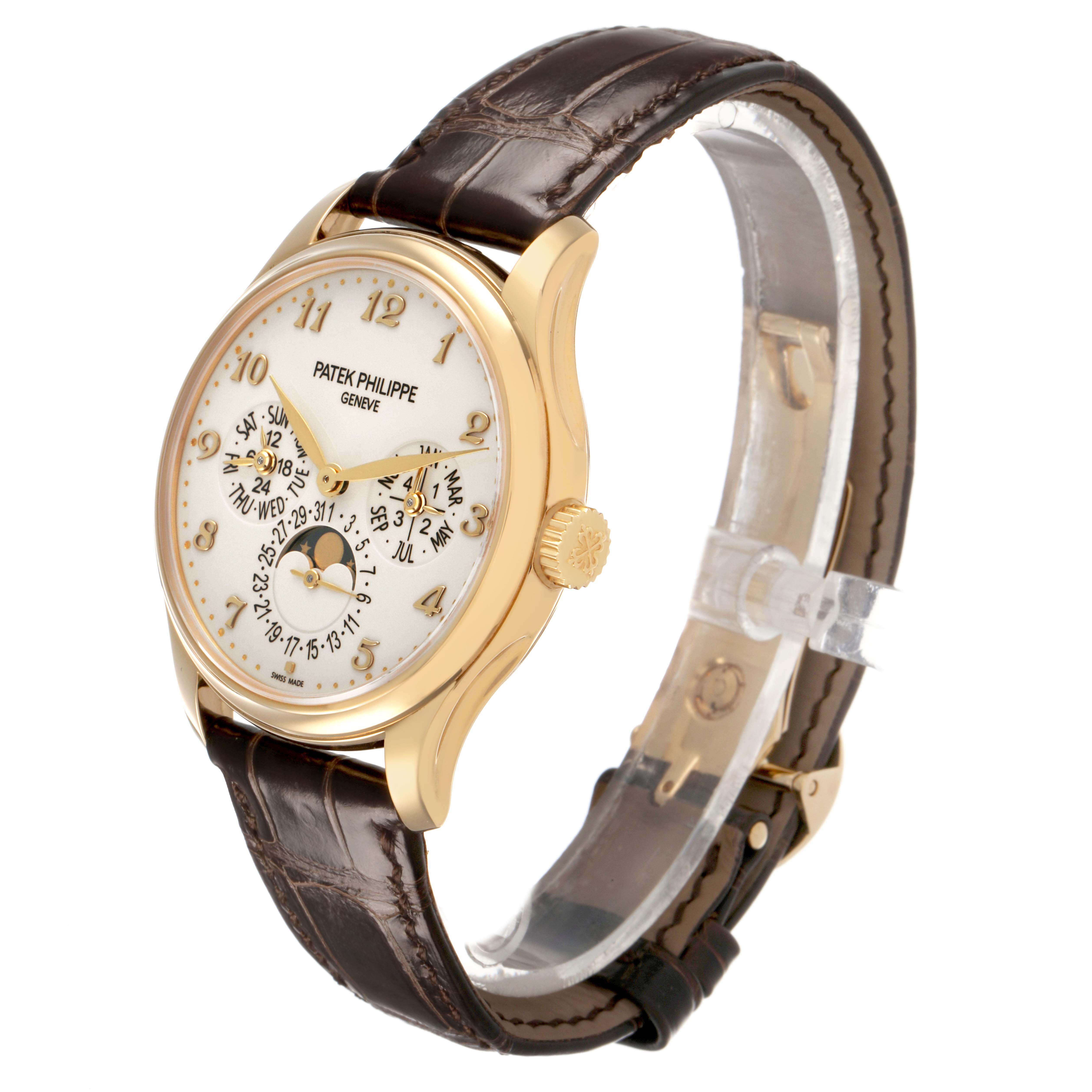 The Patek Philippe Complications 5327J-001 Men's Yellow Gold Beige Dial model is shown at a slight angle, highlighting the dial, crown, and leather strap.