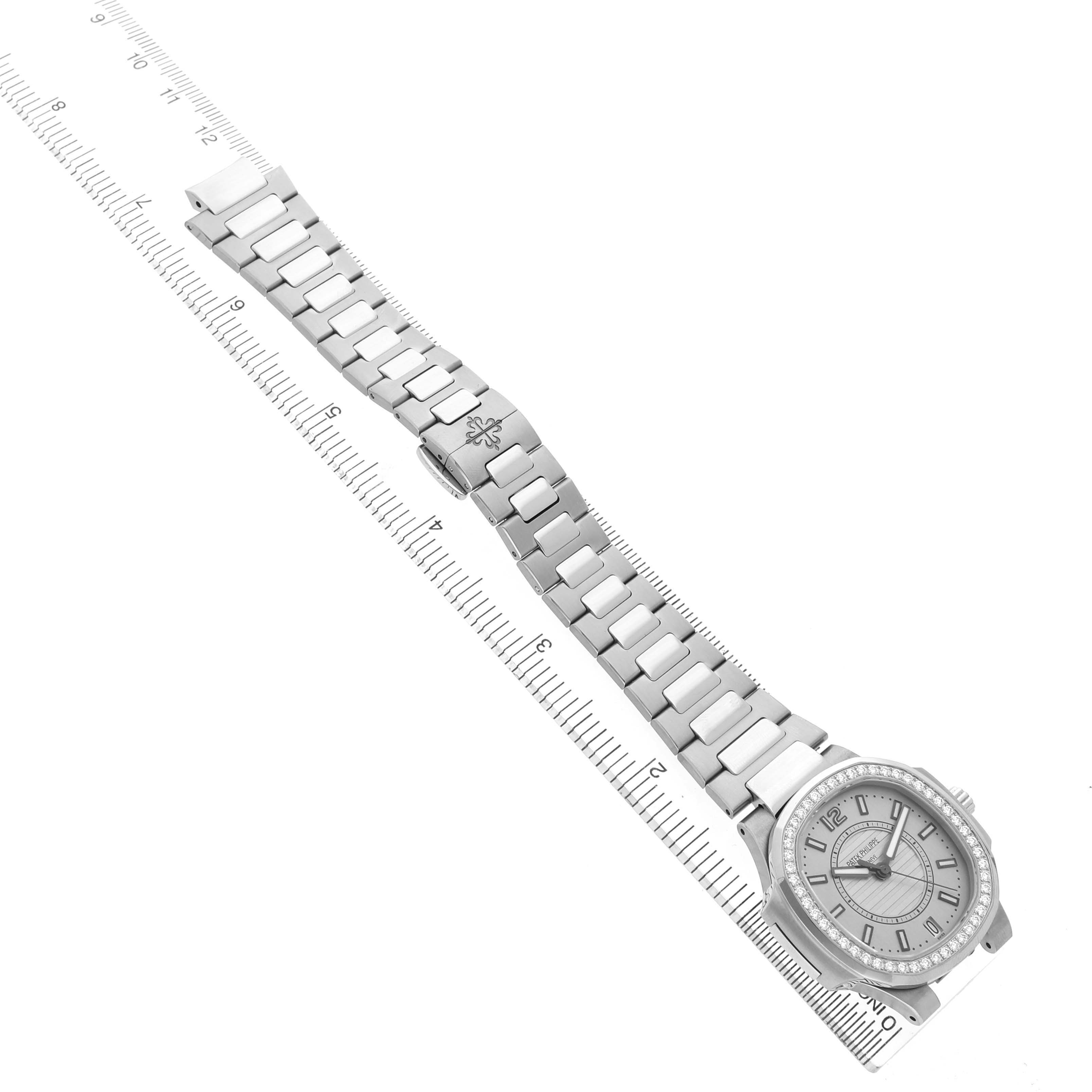 The image shows a Patek Philippe Nautilus 7008/1A-011 Women's Stainless Steel Silver Dial watch lying flat, highlighting the watch face and metal bracelet against a measurement scale.
