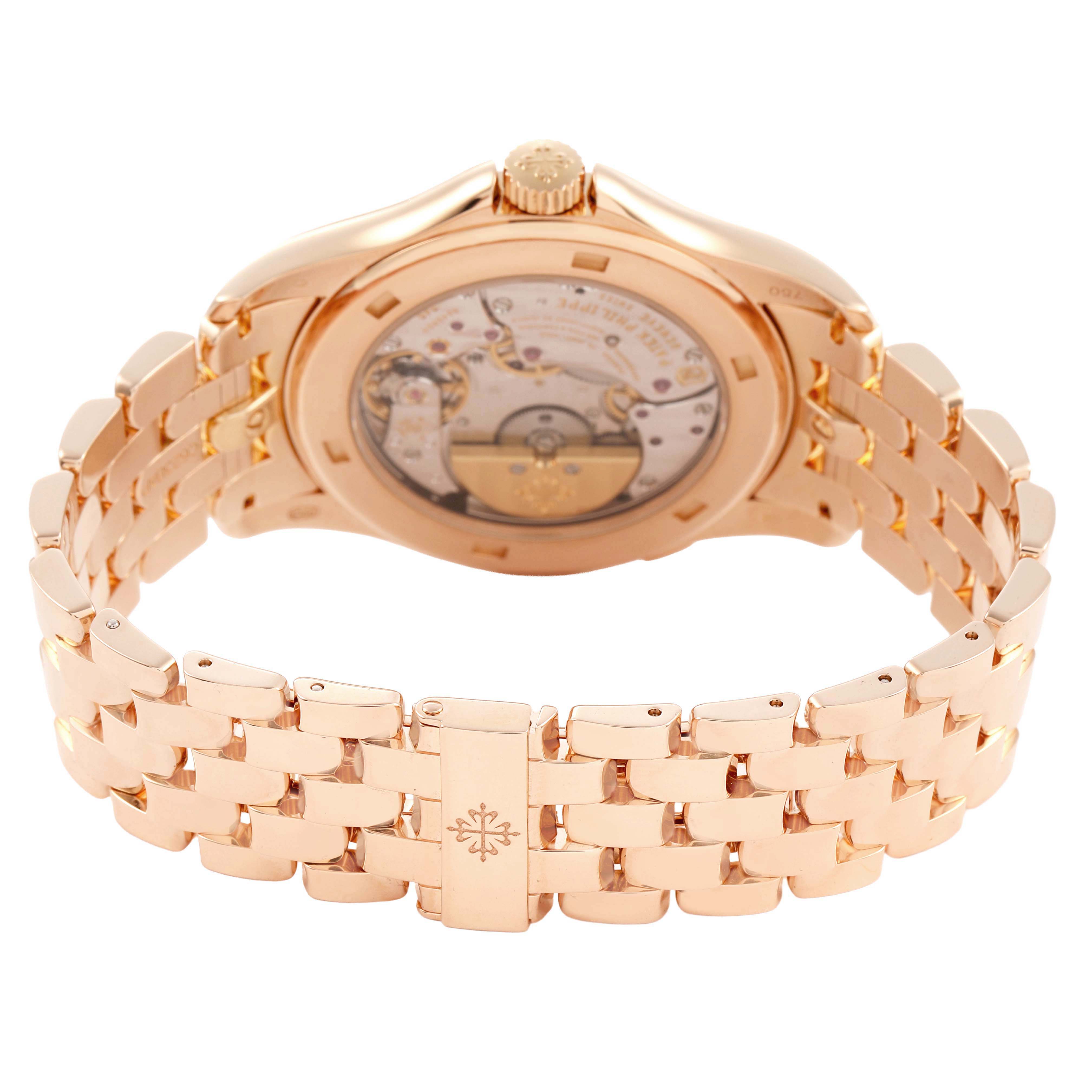 The image shows the Patek Philippe Complications 5130/1R-011 Men's Rose Gold Brown Dial watch from the rear, highlighting the gold bracelet and transparent case back.