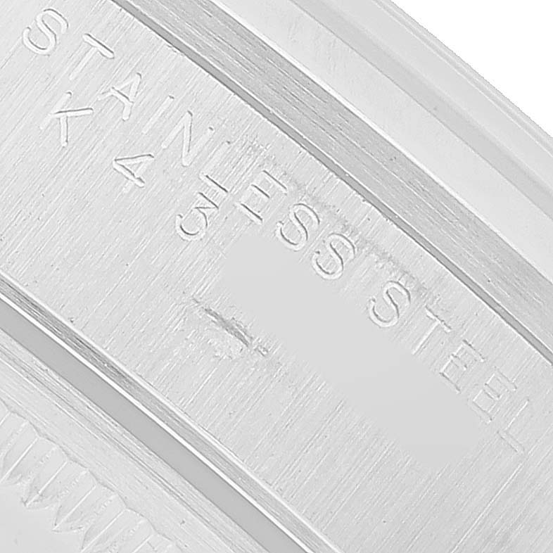 The image shows an angled close-up of the stainless steel case back of a Rolex Air-King 14000 Men's Stainless Steel Silver Dial watch.