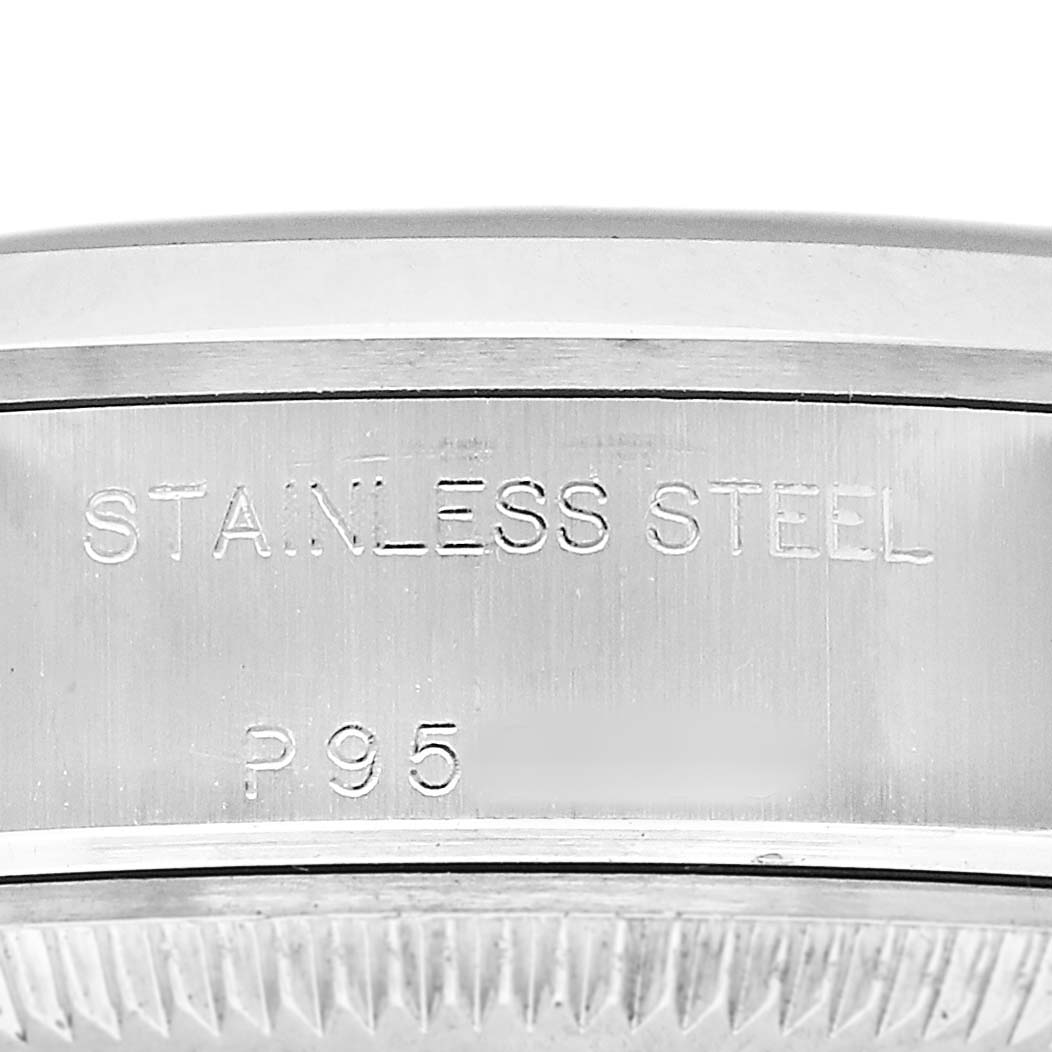 The image shows a close-up of the side of a Rolex Date 79160 Women's Stainless Steel Blue Dial model with "STAINLESS STEEL" etched on the casing.