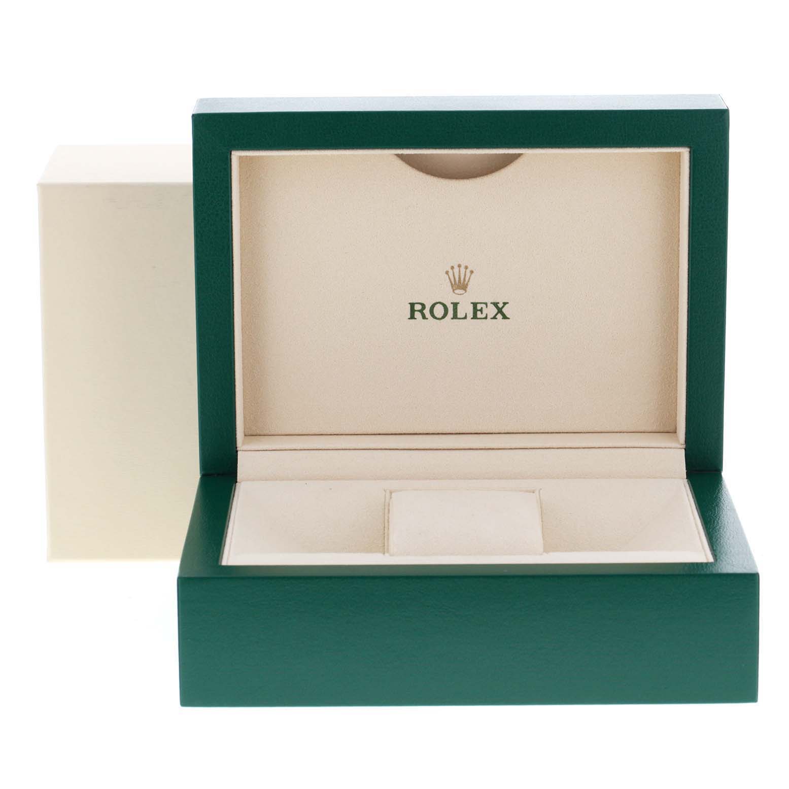 This image shows an open green and beige Rolex box for a Datejust model watch.