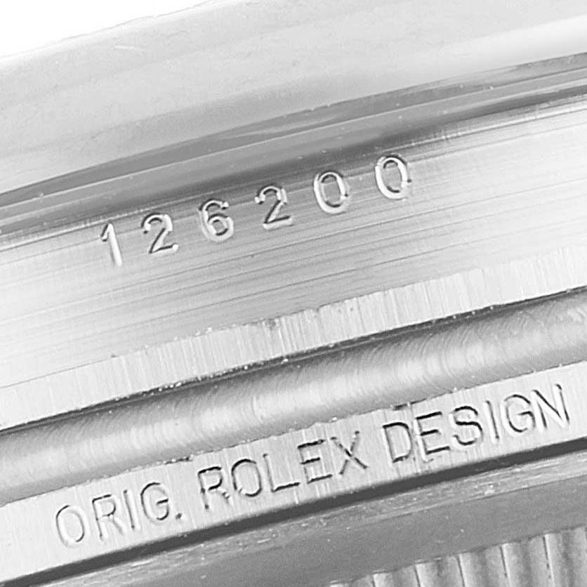 This close-up shows the model number and "ORIG. ROLEX DESIGN" engraving on the side of a Rolex Datejust 126200 Men
s Stainless Steel Blue Dial 126200 Men
s Stainless Steel Blue Dial watch.