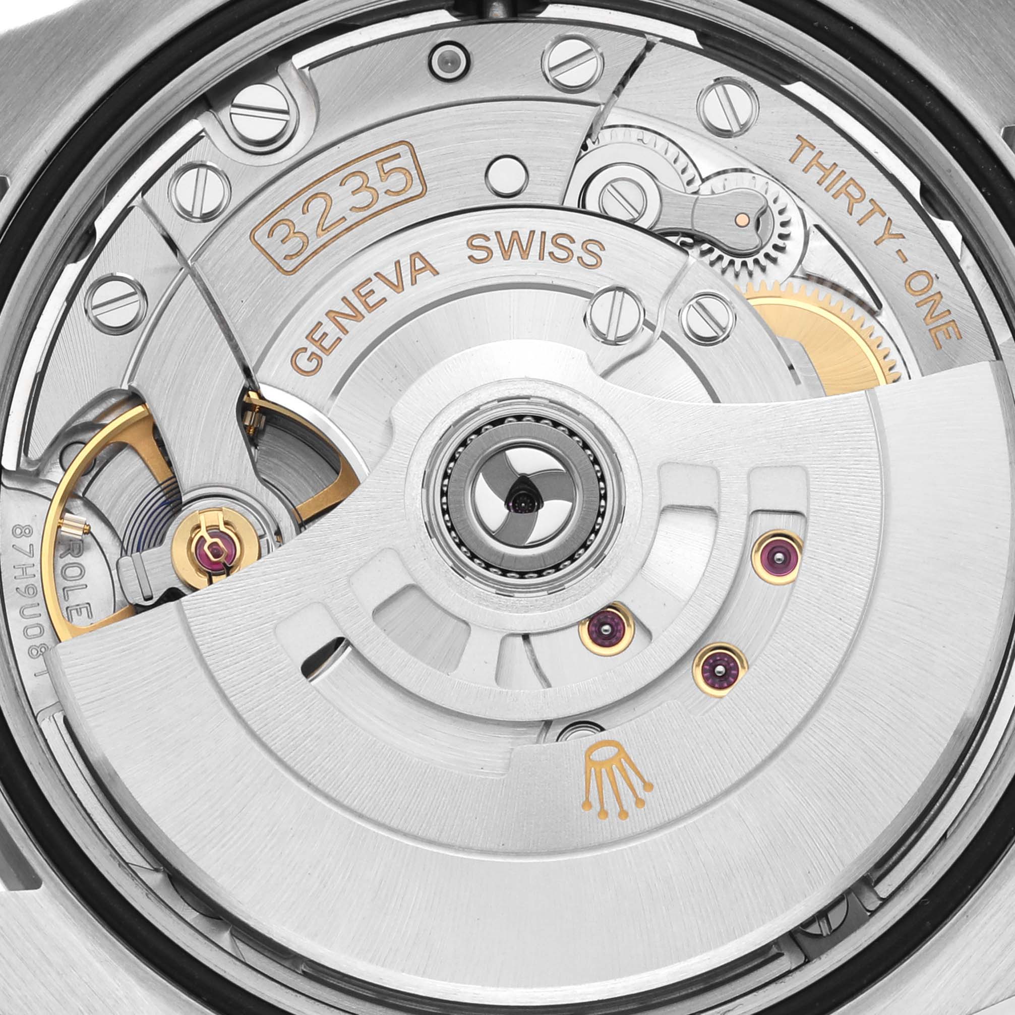 The image shows a close-up of the Rolex Datejust 126200 Men's Stainless Steel Blue Dial 126200 Men's Stainless Steel Blue Dial watch's movement, highlighting the 3235 caliber and intricate internal mechanisms.