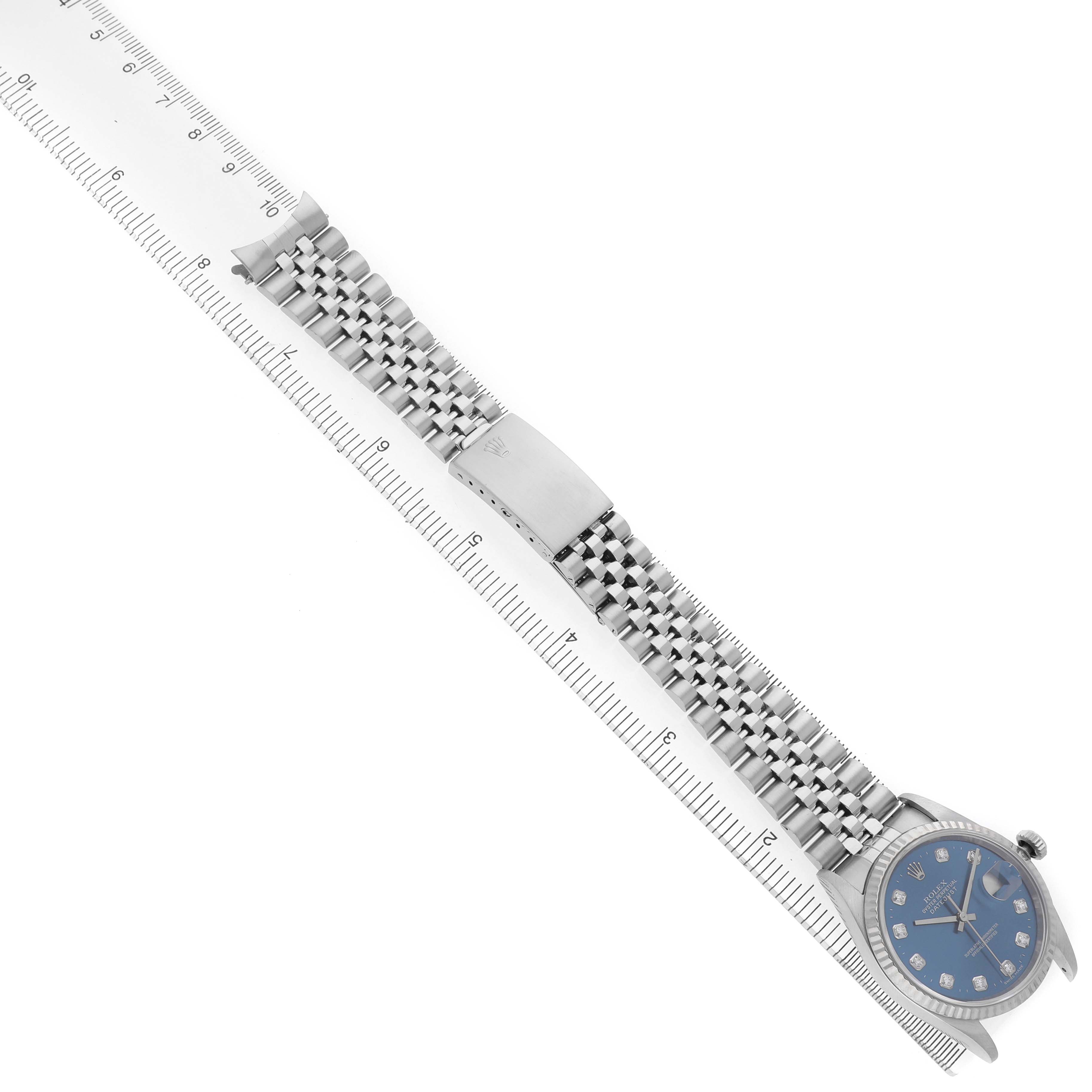 The image shows a Rolex Datejust 16234 Men's Stainless Steel Blue Dial watch from a top-down angle, highlighting the bracelet, clasp, and partial view of the watch face.
