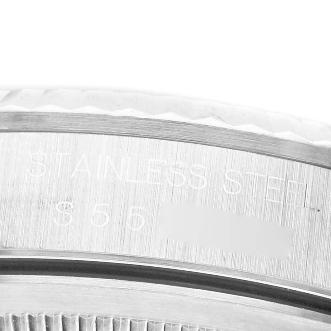 The image shows a close-up of the stainless steel bezel and edge of the case on a Rolex Datejust 16234 Men's Stainless Steel Blue Dial watch.