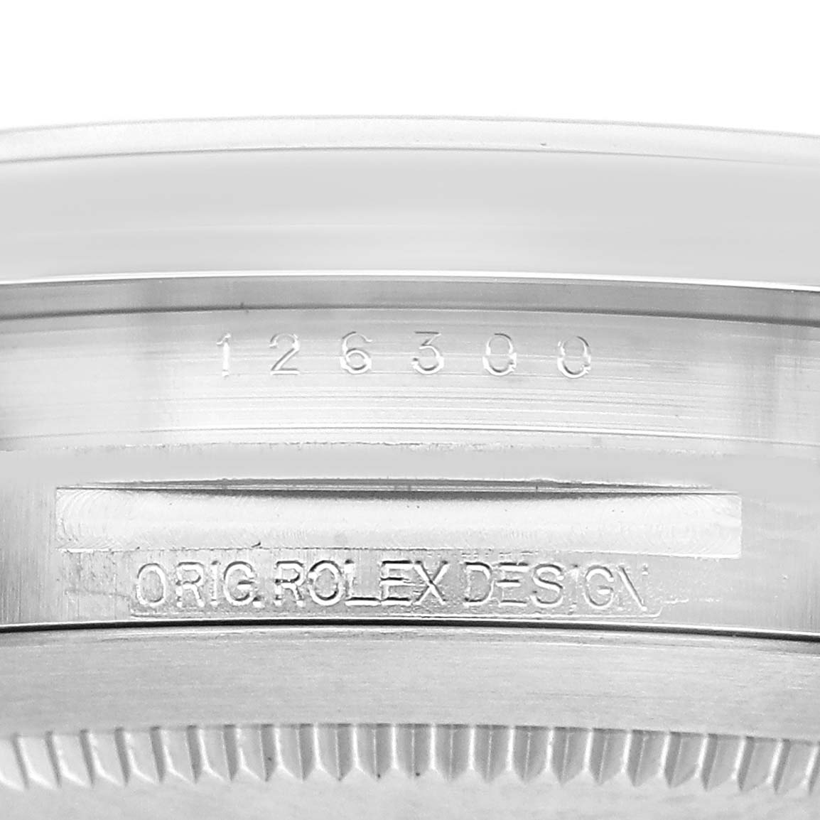 The image shows the engravings on the inner bezel of a Rolex Datejust 41 126300 Men's Stainless Steel Black Dial, displaying the model number and "ORIG. ROLEX DESIGN."