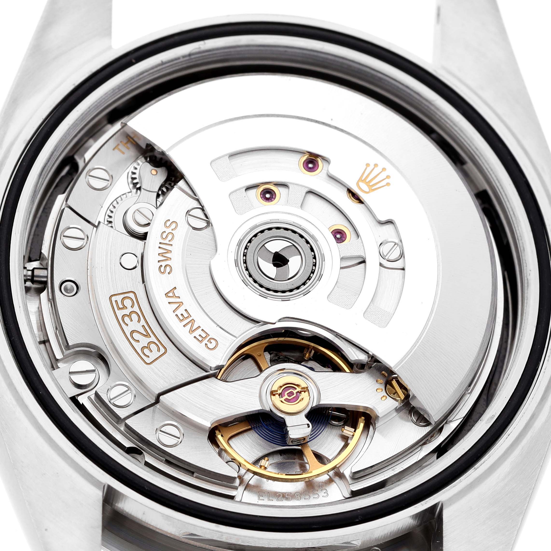 The image shows a close-up of the Rolex Datejust 41 M126334-0018 Men's Stainless Steel Black Dial's movement, highlighting the rotor and gears from the back.
