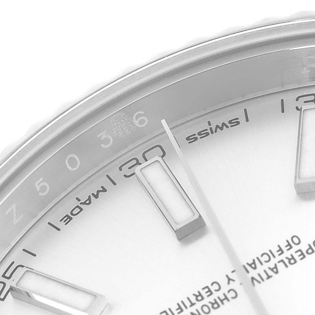 The image shows a close-up of the Rolex Datejust 41 126334 Men
s Stainless Steel Silver Dial 126334 Men
s Stainless Steel Silver Dial dial, focusing on the hour markers, part of the dial, and text details.