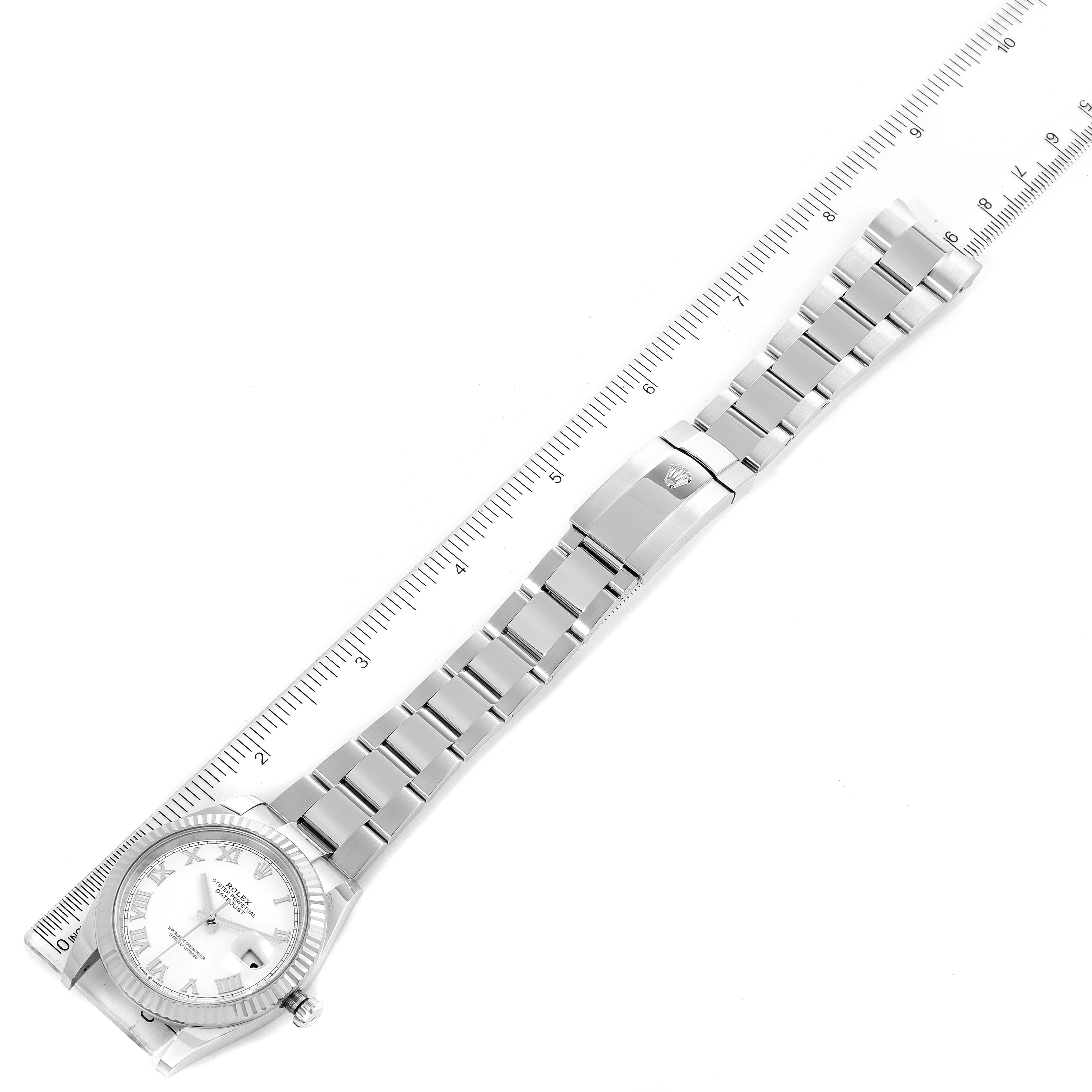The image shows the Rolex Datejust 41 126334 Men
s Stainless Steel White Dial 126334 Men
s Stainless Steel White Dial model laid flat with a ruler beside it, highlighting the watch band and clasp.