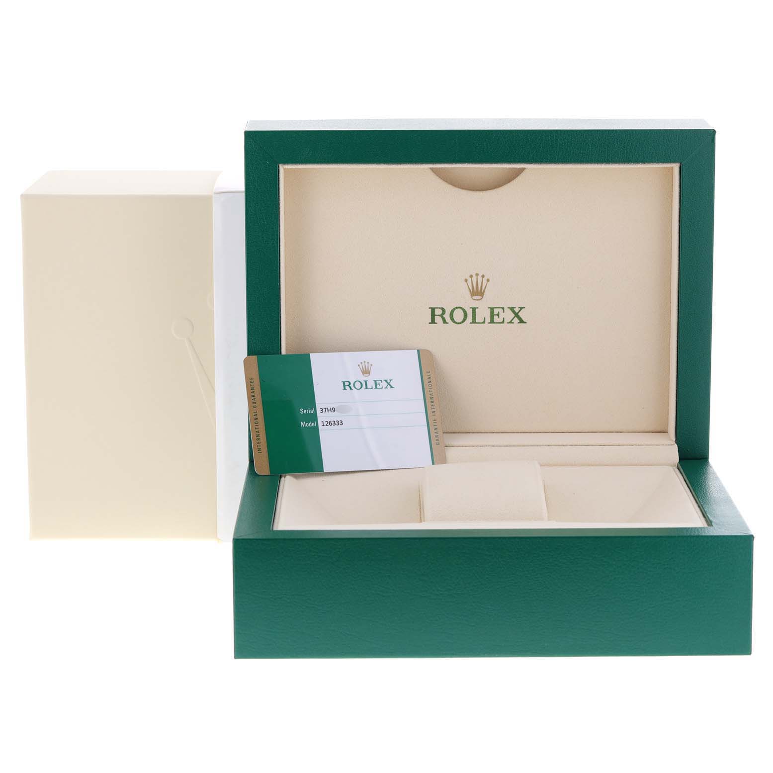 The image shows the packaging and warranty card for the Rolex Datejust 41 126333 Men's Steel and Gold (two tone) Black Dial 126333 Men's Steel and Gold (two tone) Black Dial watch.