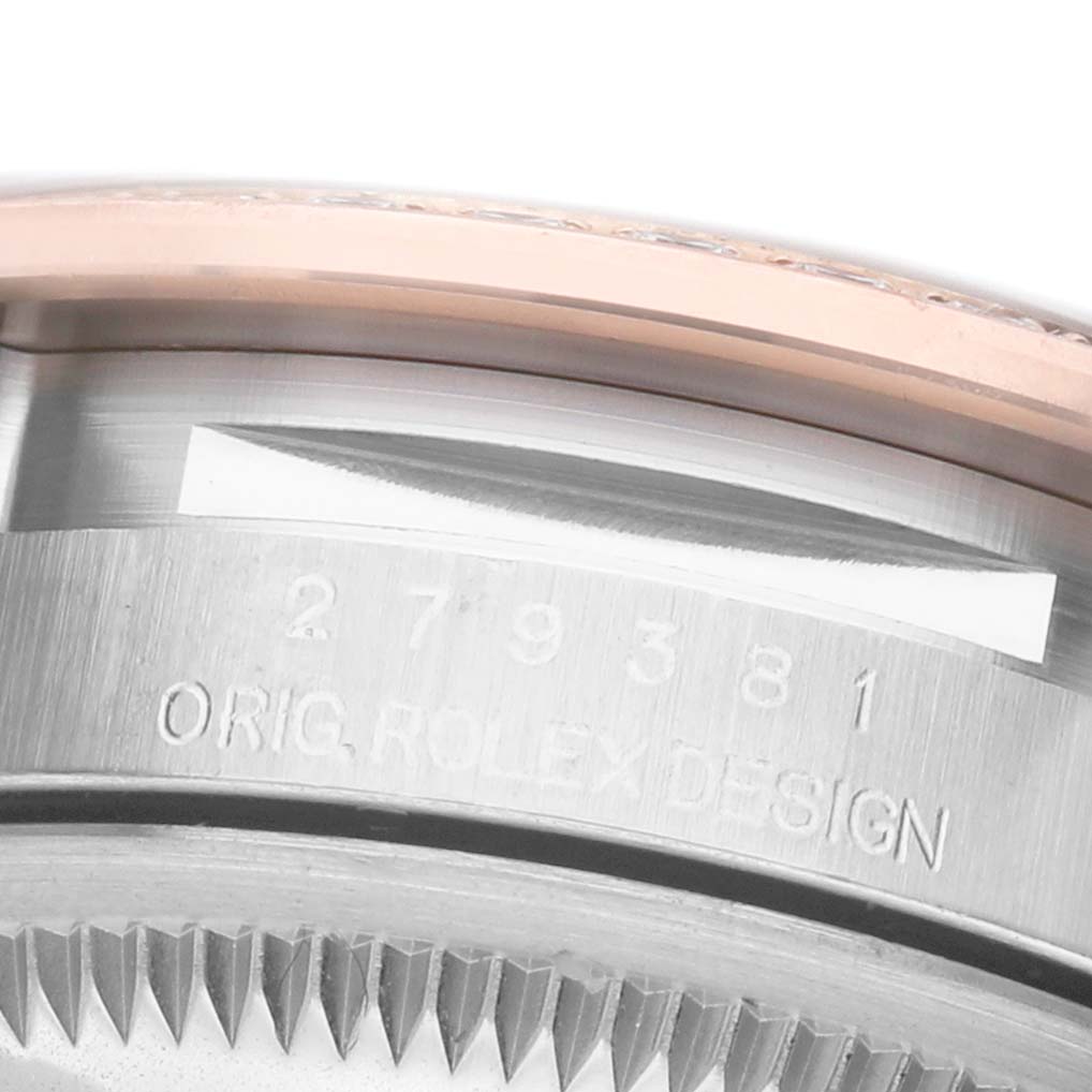 The image shows a close-up of the Rolex Datejust 279381 Women's Steel and Gold (two tone) Purple Dial watch, highlighting the bezel, case edge, and part of the serial number engraving.