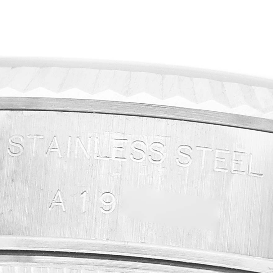 The image shows a close-up of the side of a Rolex Datejust 79174 Women's Stainless Steel Pink Dial's case with "STAINLESS STEEL" and other markings visible.